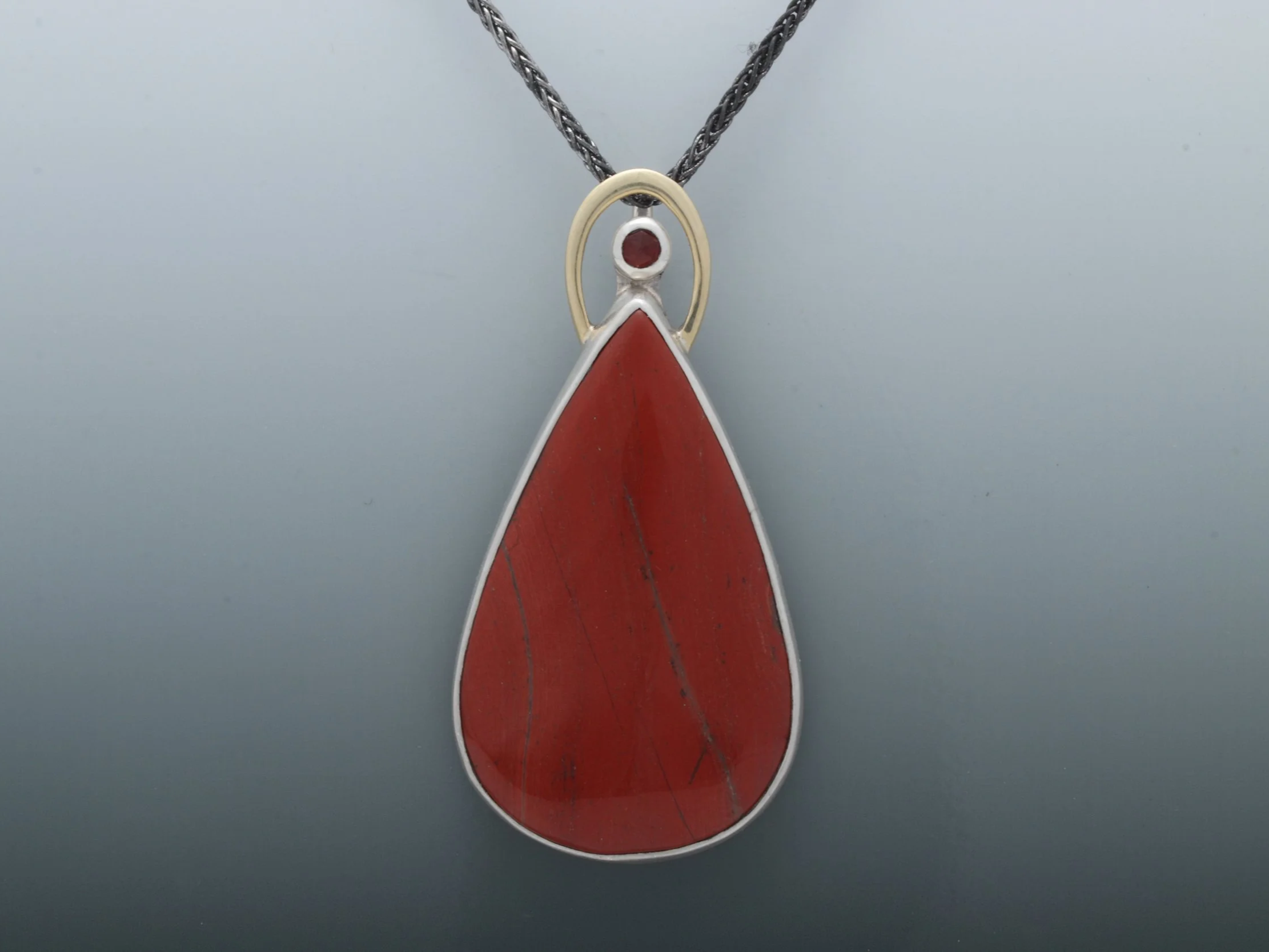 "Cardinal" pendant. Red jasper and garnet, set in silver with a halo of hammer forged 14k gold