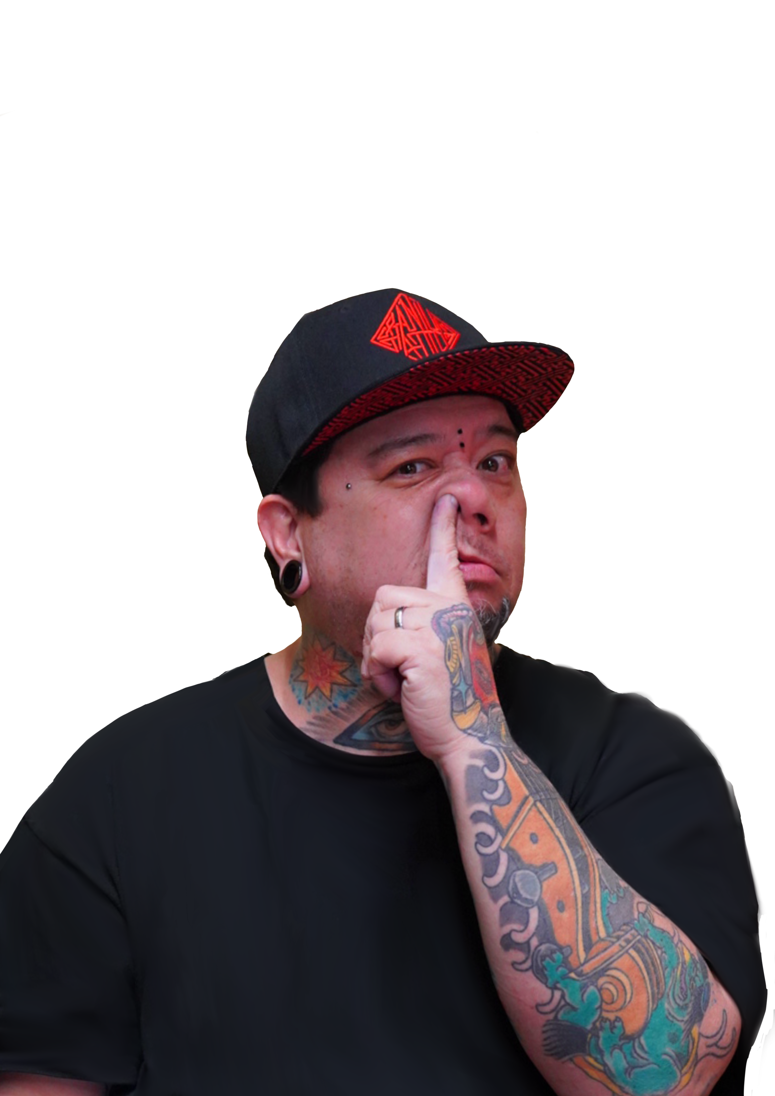 Kaw has tattoos on his arm and face wearing a black and red cap, touching their nose with their finger, against a background divided into red, black, and teal sections.