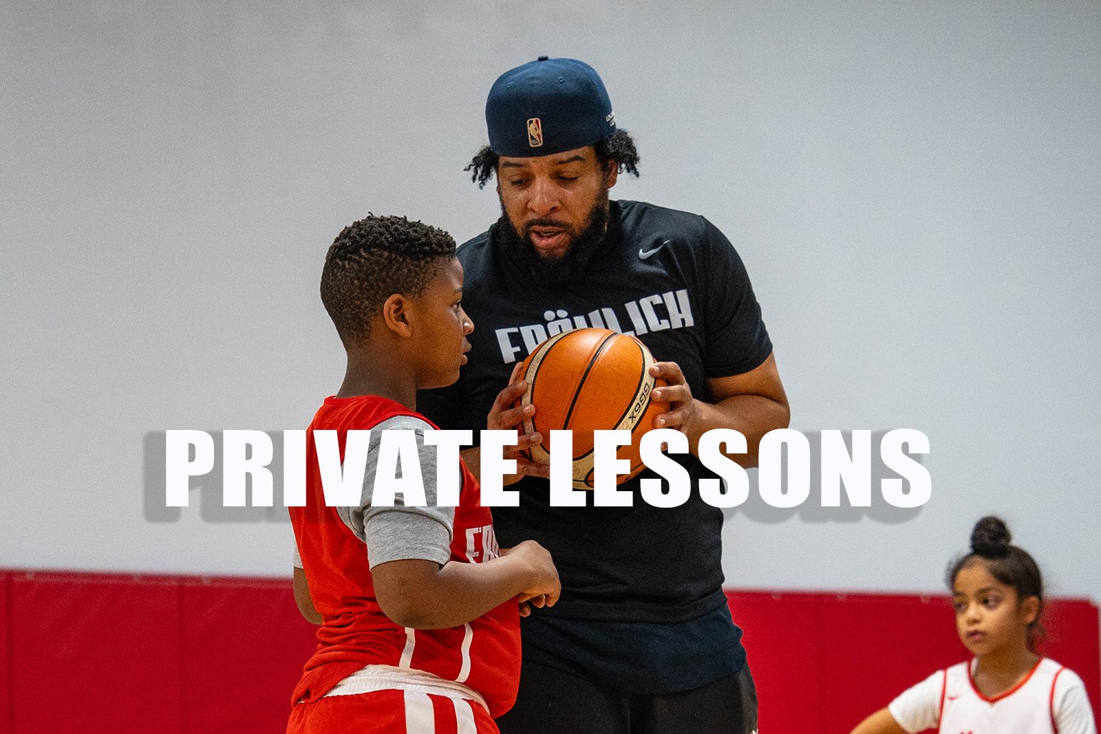 Coach teaching a young athlete how to play basketball.