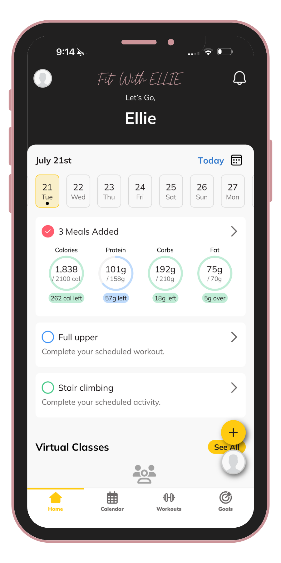 A smartphone screen displaying a fitness app called 'Fit With Ellie.' The app shows a calendar with July 21st selected, tracking meals and workouts, including bars for calories, protein, carbs, and fat intake, with daily left-over or overage amounts. The app includes sections for scheduled workouts and virtual classes, with navigation icons at the bottom for Home, Calendar, Workouts, and Goals.