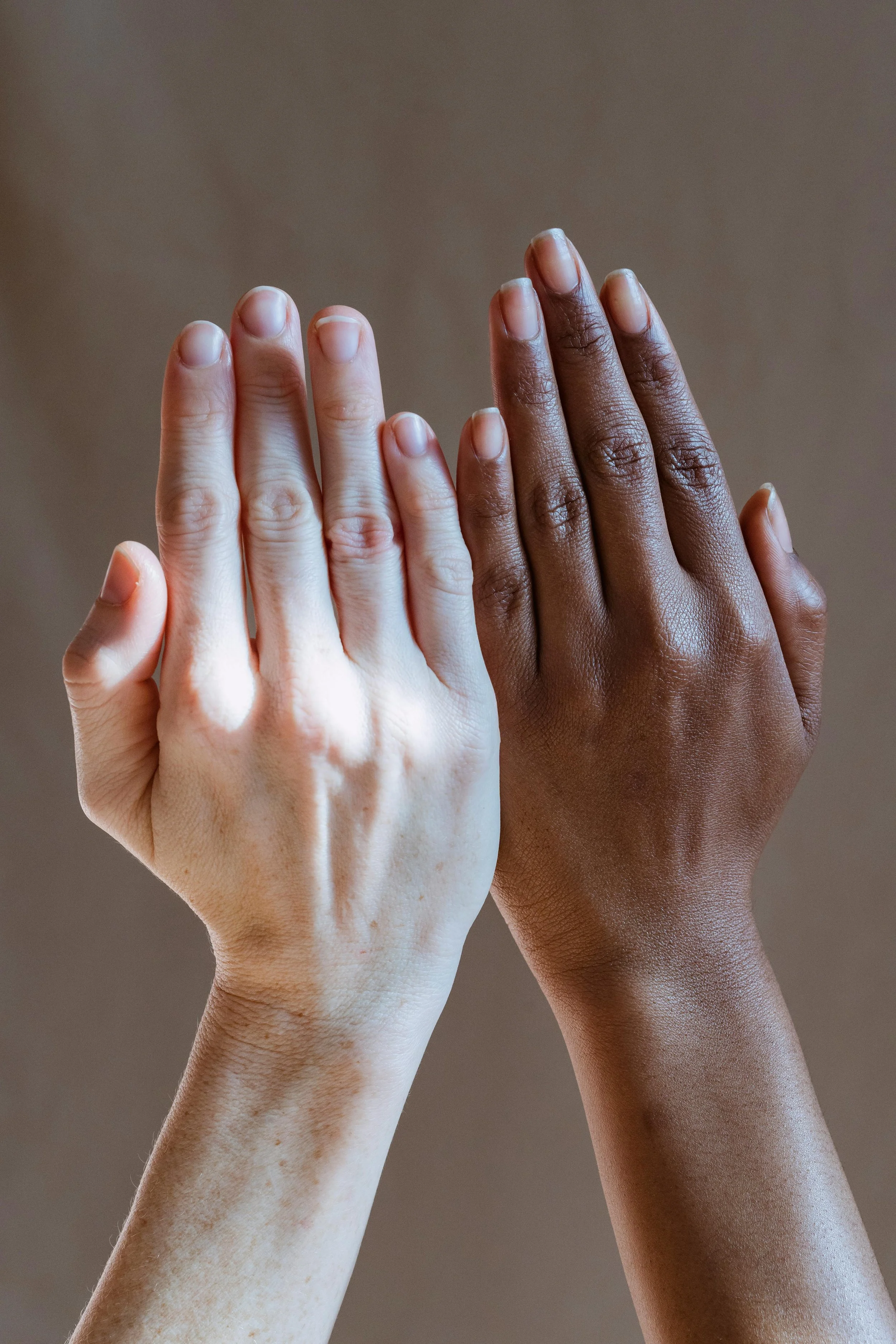 Diverse hands together, representing connection and inclusive psychotherapy support.