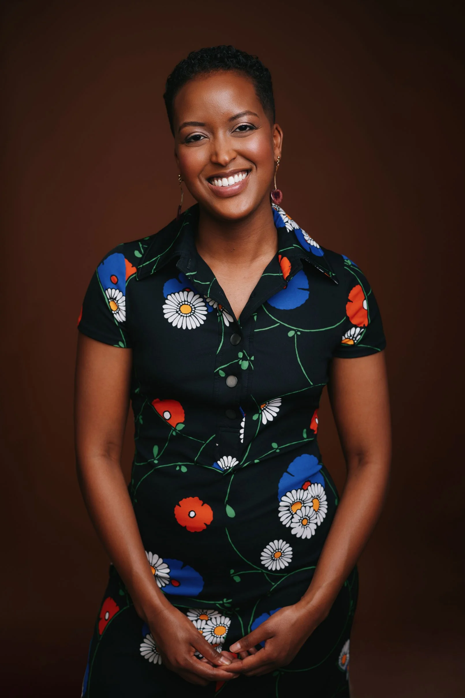 Anel Hared smiling in a professional portrait.