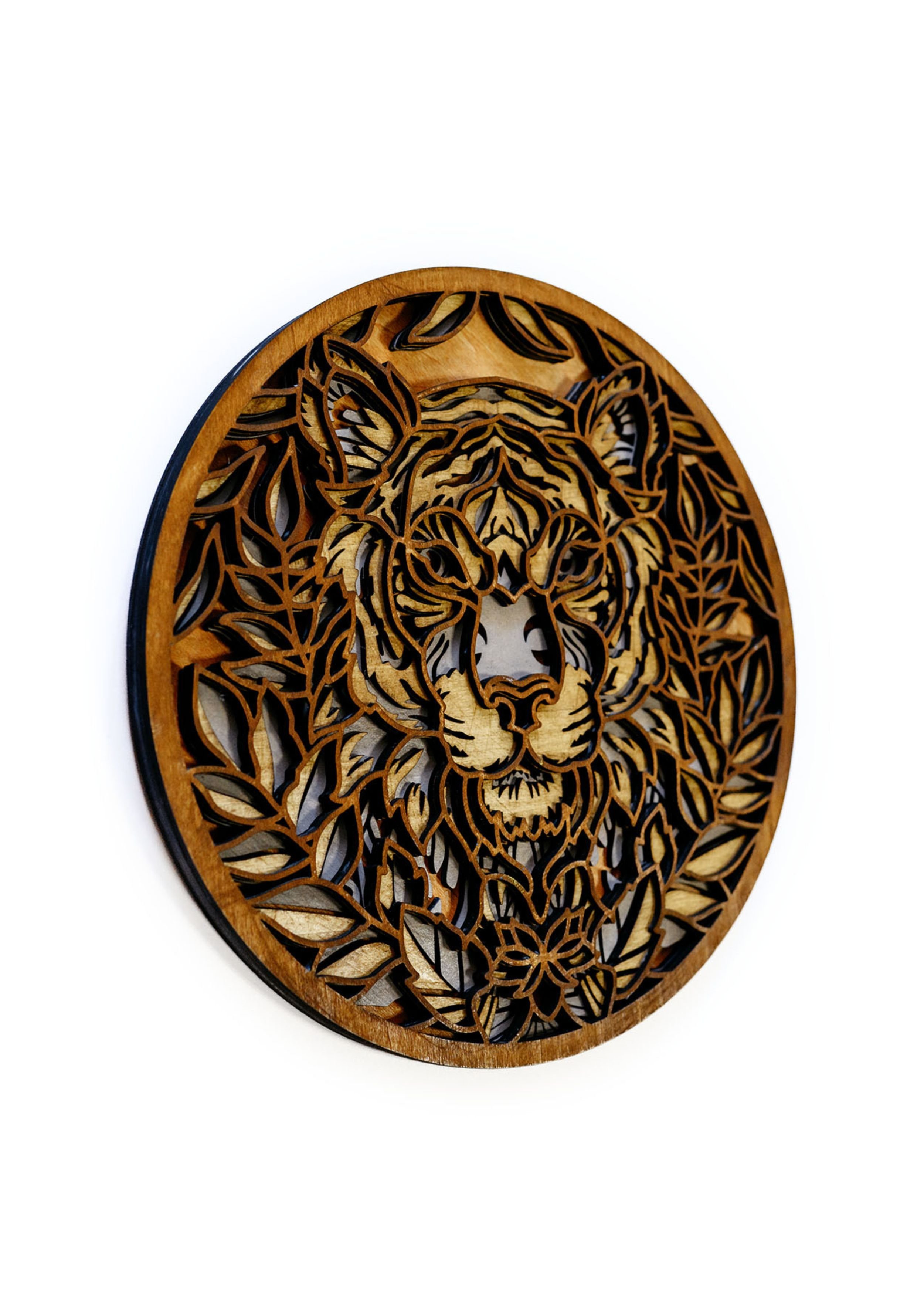 Close up detail of laser cut lion mandala wood art showing intricate layered design