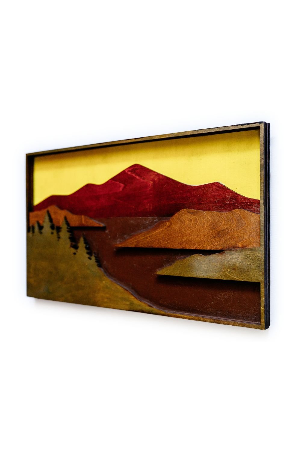 Angled view of mountain scene wood wall art highlighting layered depth and precision-cut landscape design.
