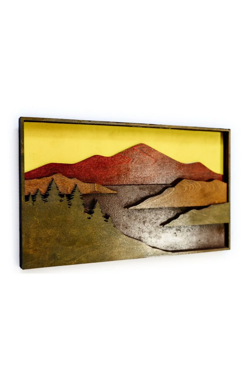 Close-up of layered wood surfaces on mountain scene wall art showing natural wood grain and finish.