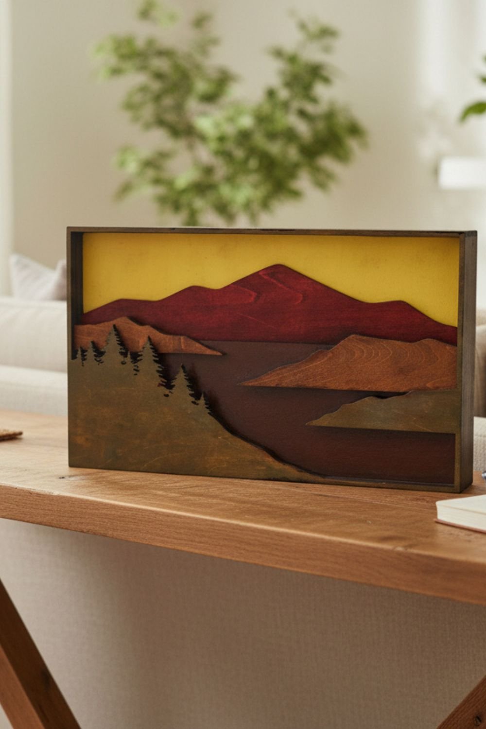 Mountain scene layered wood wall art displayed in a cabin or lodge setting for rustic décor inspiration.