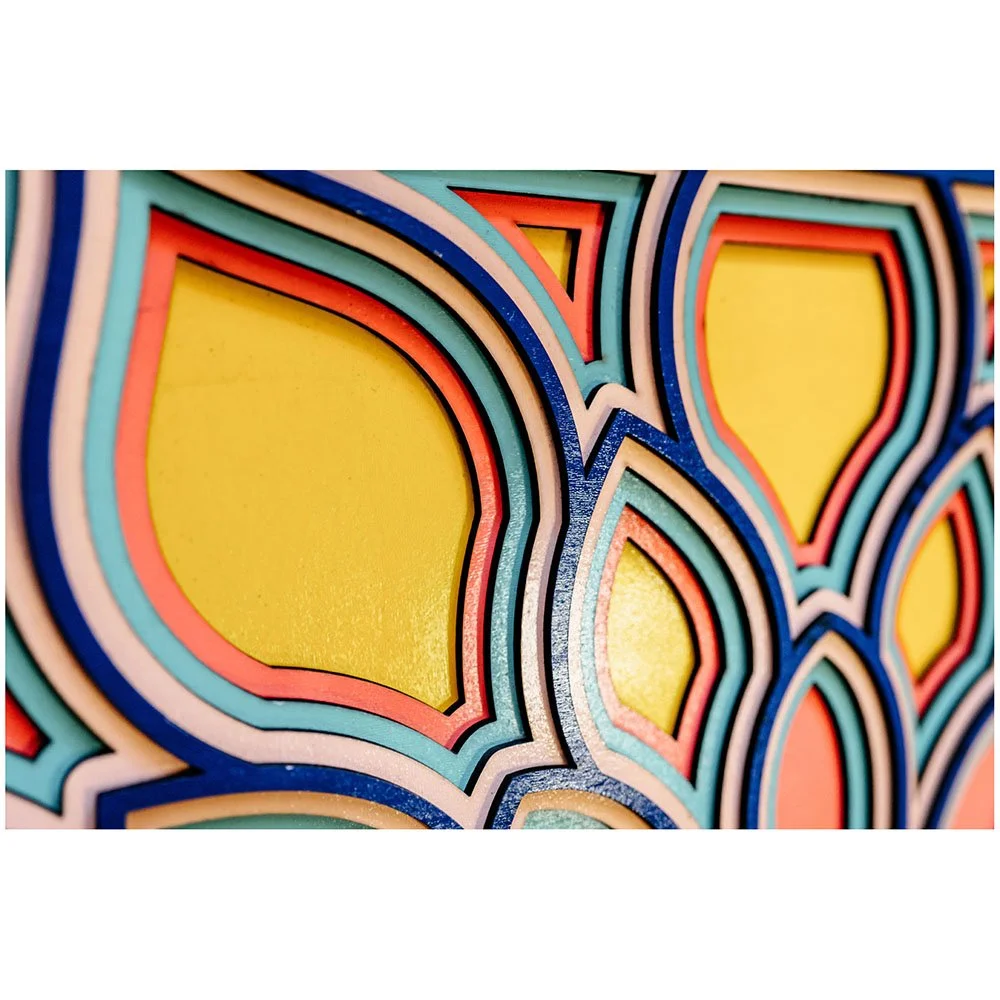 Detailed view of flower petal burst wall decor showcasing natural wood grain and painted accents