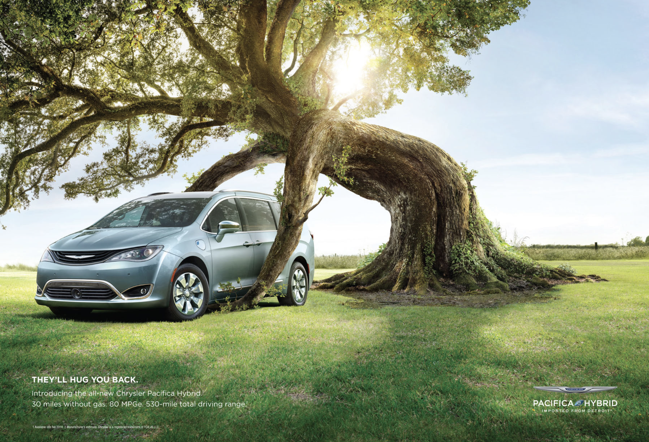 A silver Chrysler Pacifica Hybrid minivan wedged into a large tree with sprawling branches, in a grassy field under a partly cloudy sky with the sun shining through the branches. Text at the bottom left highlights the vehicle's features, including 30