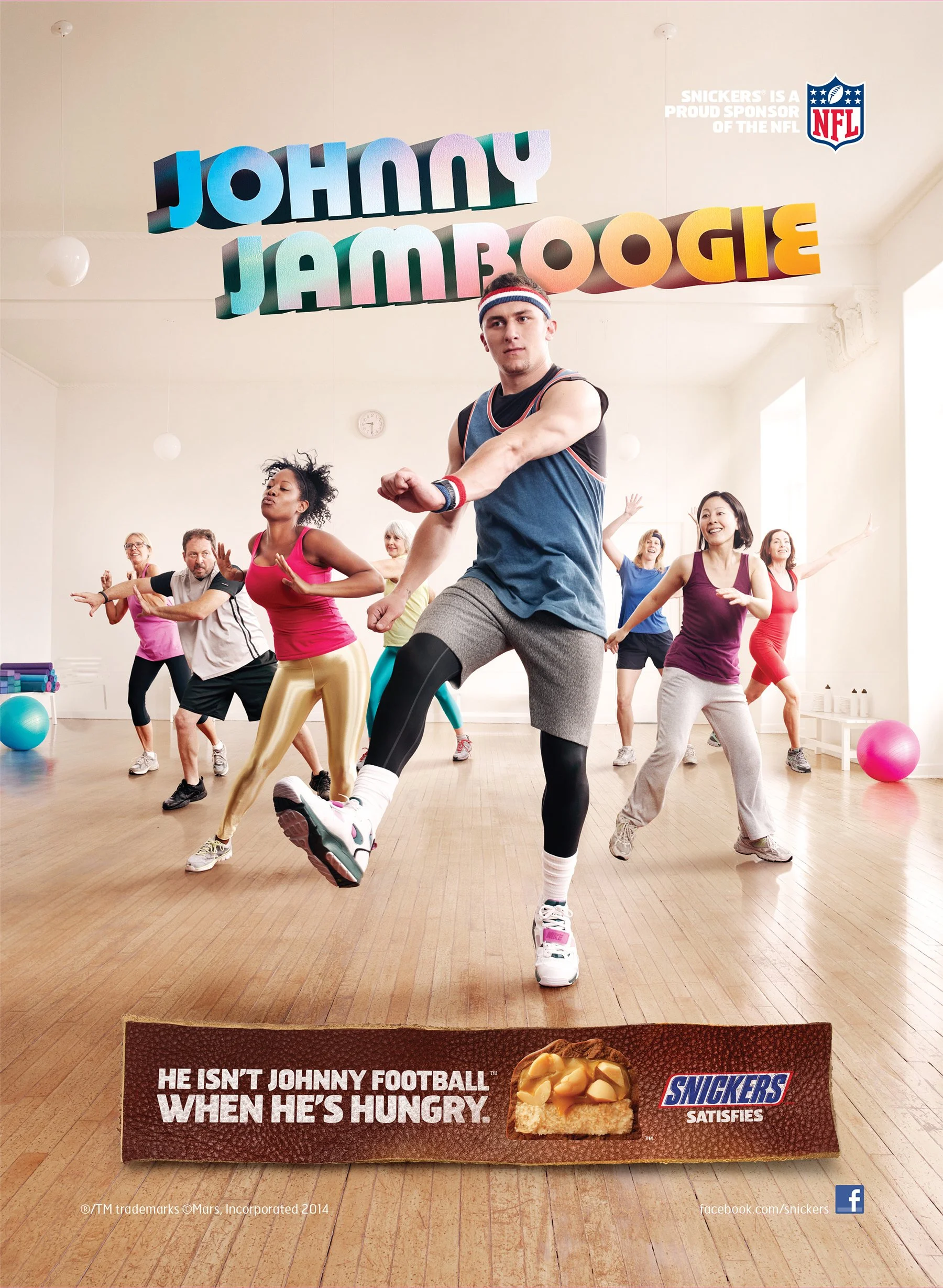 People participating in a fitness class with colorful signs hanging from the ceiling that read 'Johnny Jamboree'. A Snickers advertisement at the bottom shows a piece of Snickers cake with the caption 'He isn't Johnny Football when he's hungry.'