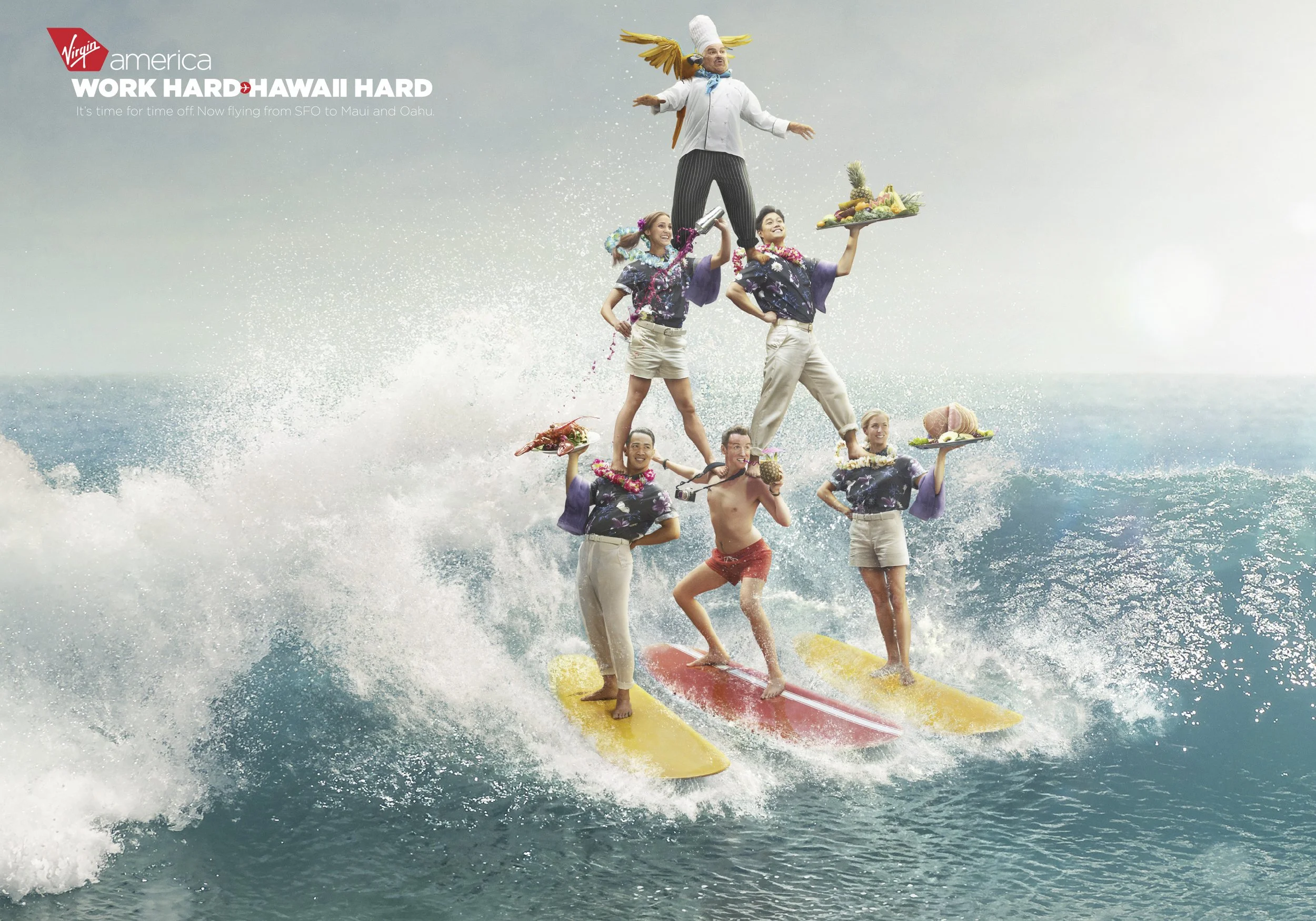 A group of seven people forming a human pyramid on surfboards in the ocean, with a chef at the top holding a pineapple, while others hold trays with food, dressed in tropical attire, celebrating Hawaii.