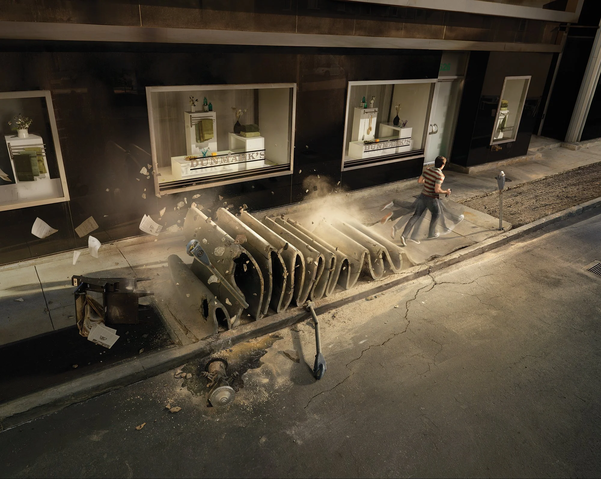 A man walking past upside-down metal barricades and debris on the sidewalk at night, near a store window displaying home decor items, with a parking meter and streetlamp nearby.
