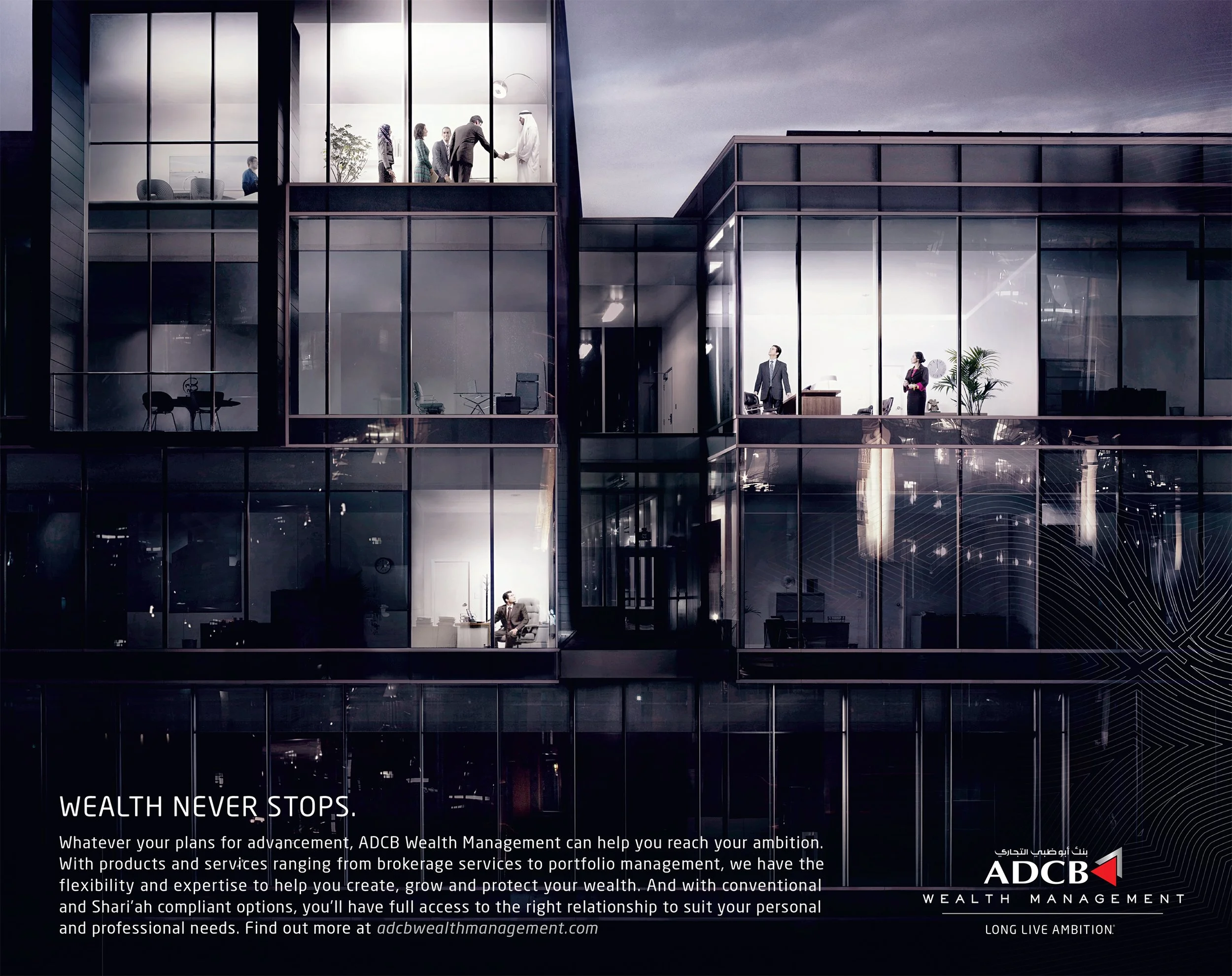 Nighttime view of a modern office building with illuminated interior floors. Several people are seen inside, engaging in work and meetings. The lower left corner features the text "WEALTH NEVER STOPS" and details about AD CB wealth management service