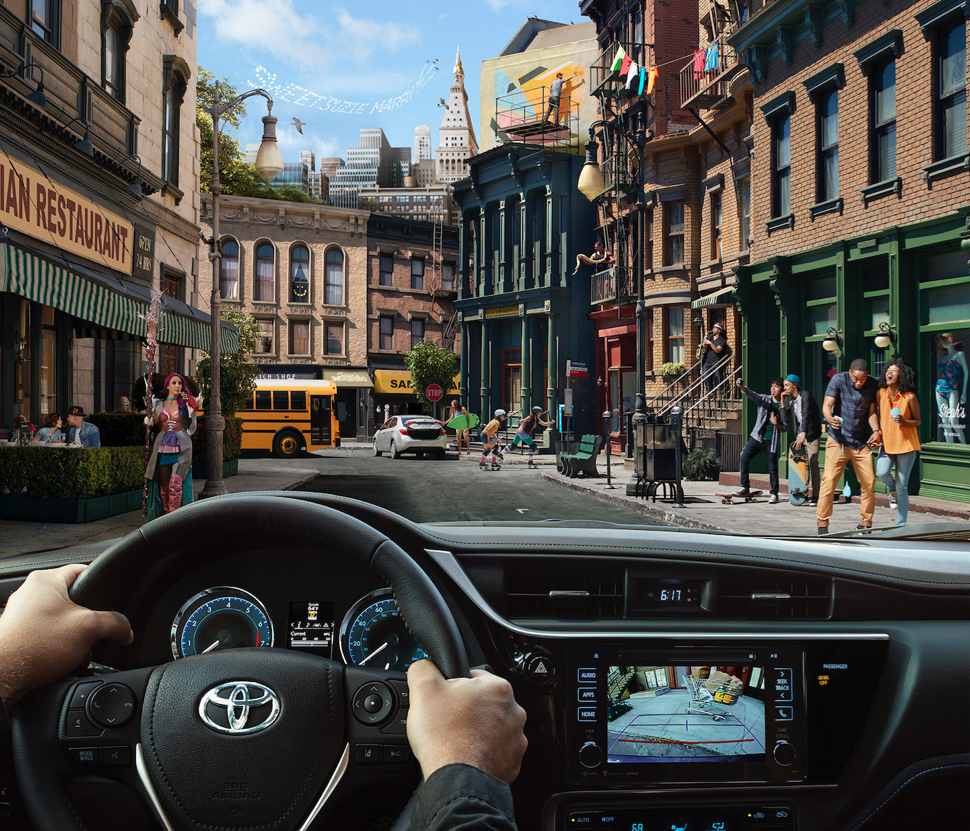 View from inside a car showing a city street scene with pedestrians and skateboarders, buildings, a school bus, and a skyline.