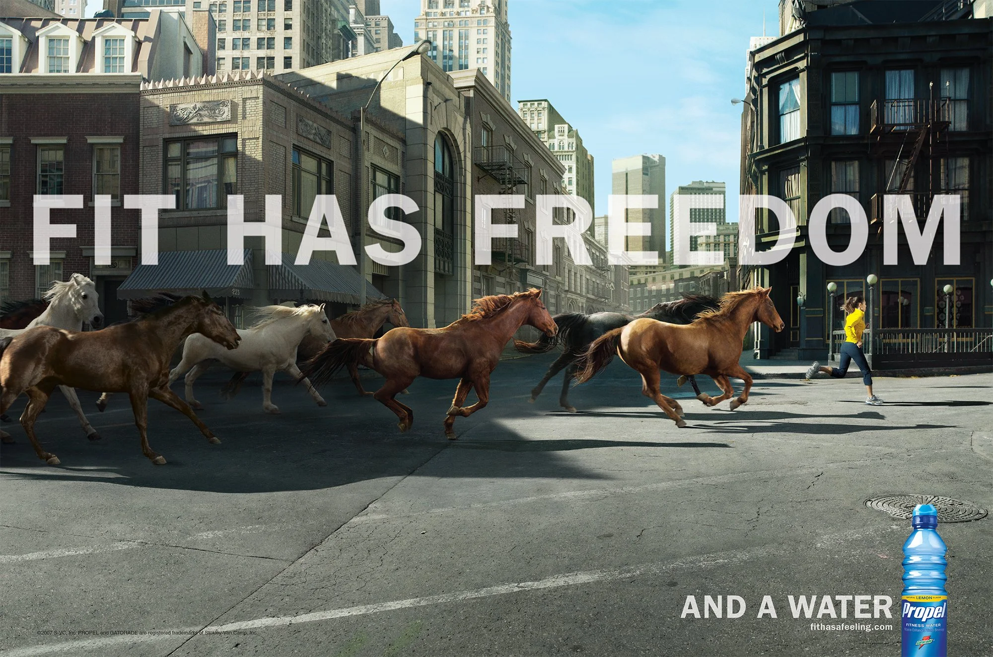 A city street with a group of running horses and a woman in a yellow jacket running alongside them. A water bottle in the foreground and the text 'FIT HAS FREEDOM AND A WATER' overlaid on the image.