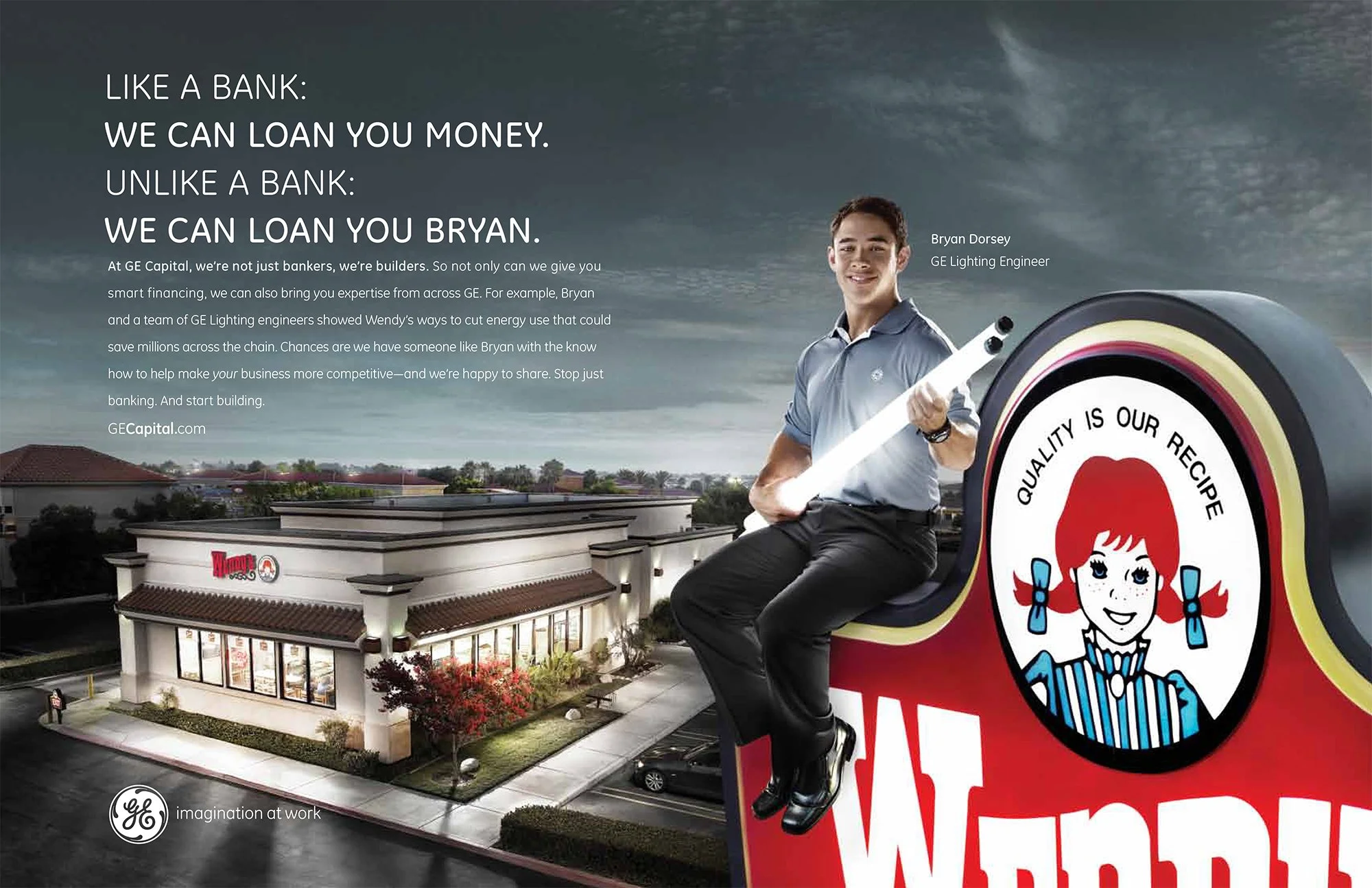 An advertisement for GE Capital showcasing Bryan Dorsey, a GE Lighting Engineer, sitting on a Wendy's sign with a Wendy's restaurant in the background, at dusk.
