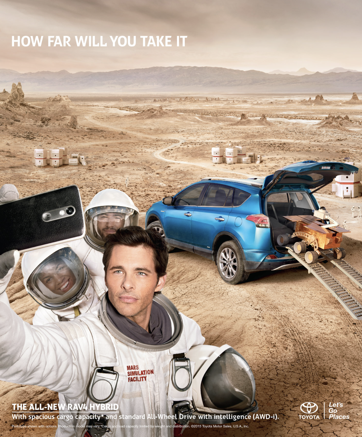 Two astronauts taking a selfie in a desert landscape in space suits with a blue SUV and a toy train on tracks in the background. The image promotes the Toyota RAV4 Hybrid.