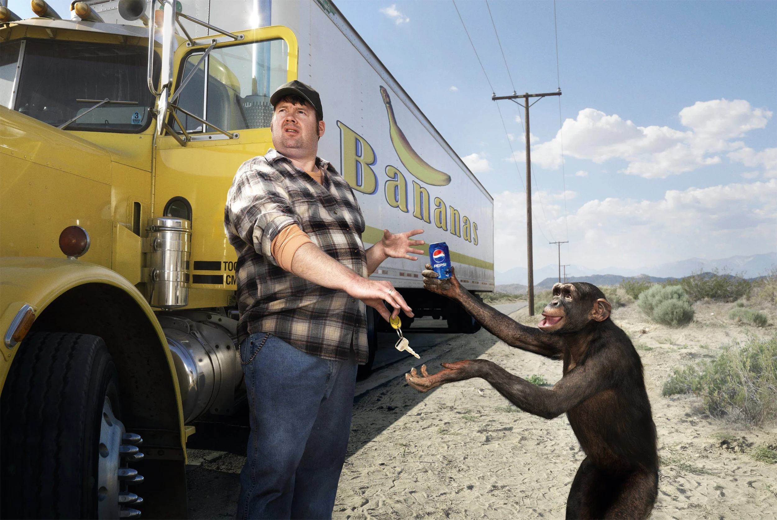 A man in a plaid shirt and jeans is standing next to a yellow banana truck, while a monkey is handing him a can of Pepsi. The setting is a desert landscape with power lines and a blue sky with clouds.