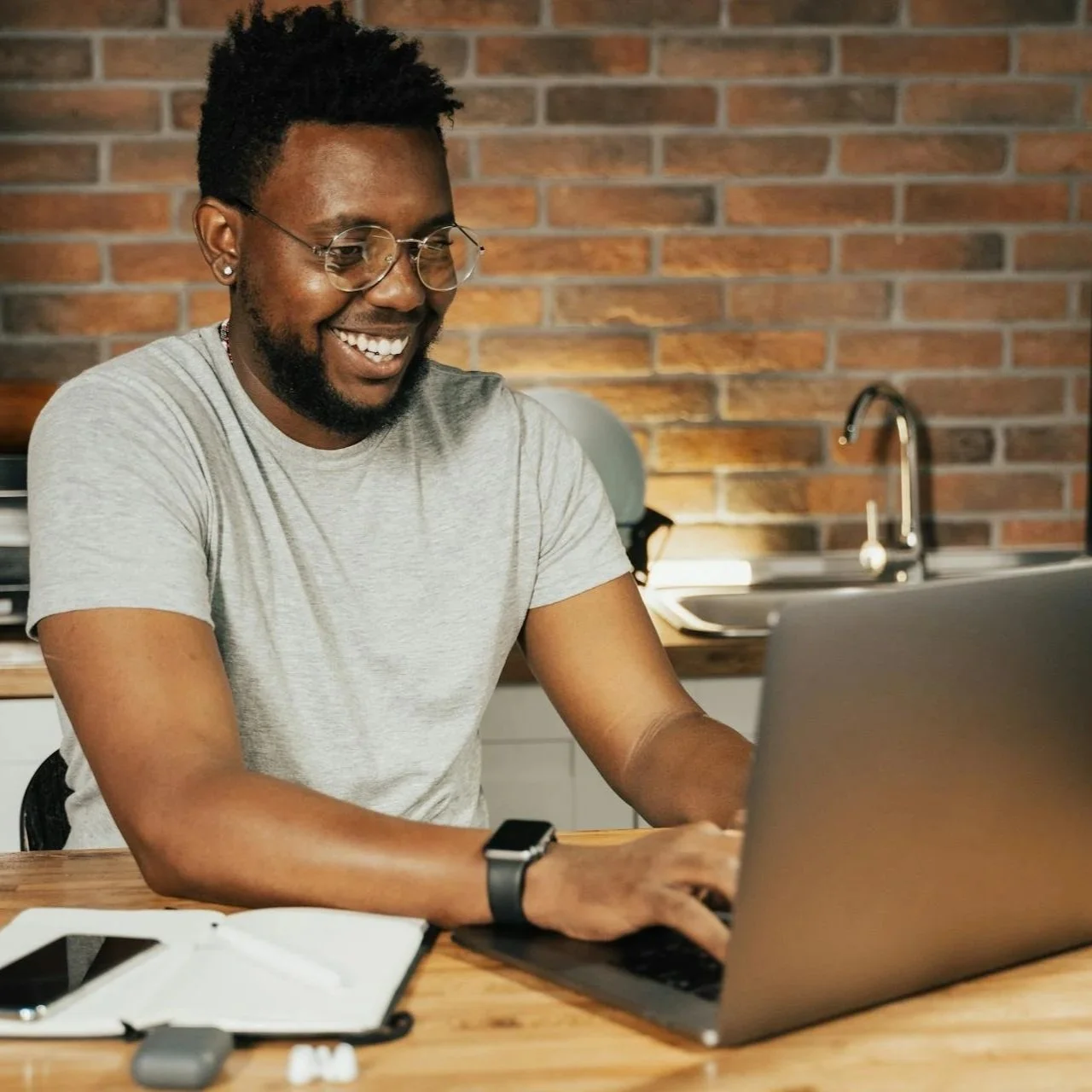 Person using laptop at home representing online ADHD therapy and coaching for adults.