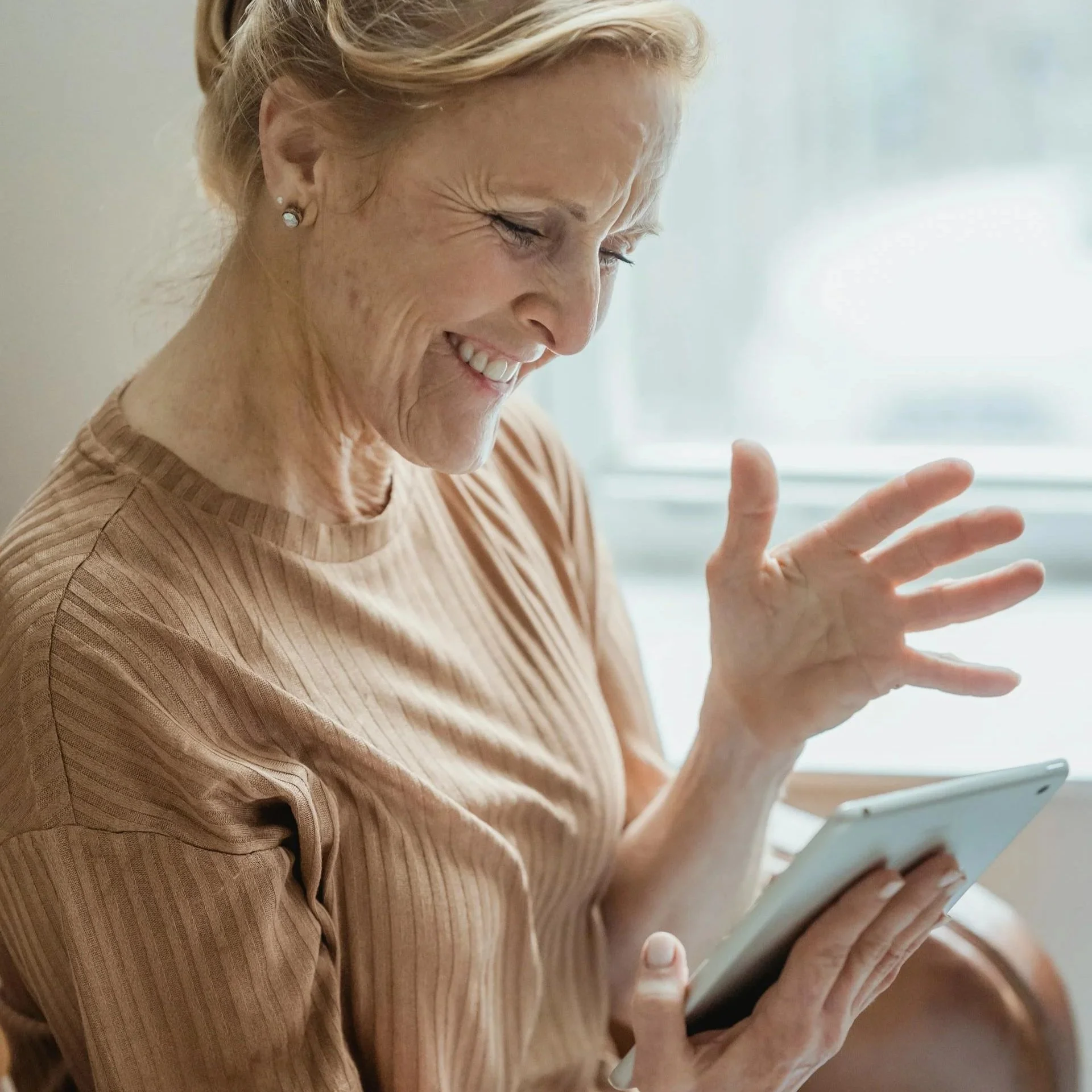 Woman using tablet representing ADHD and autism assessments and diagnosis services