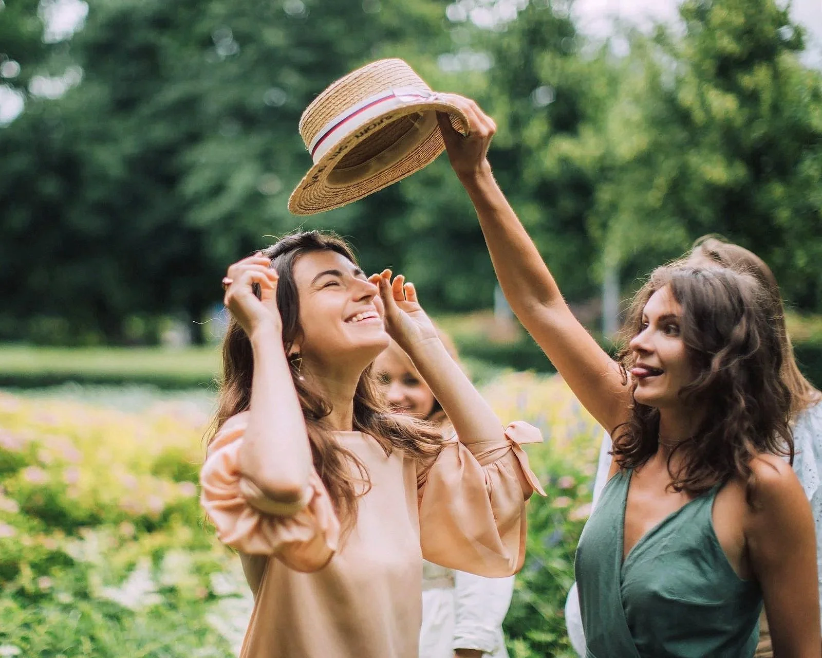 Group of friends smiling outdoors in a park, representing supportive relationships and wellbeing in ADHD and autism care