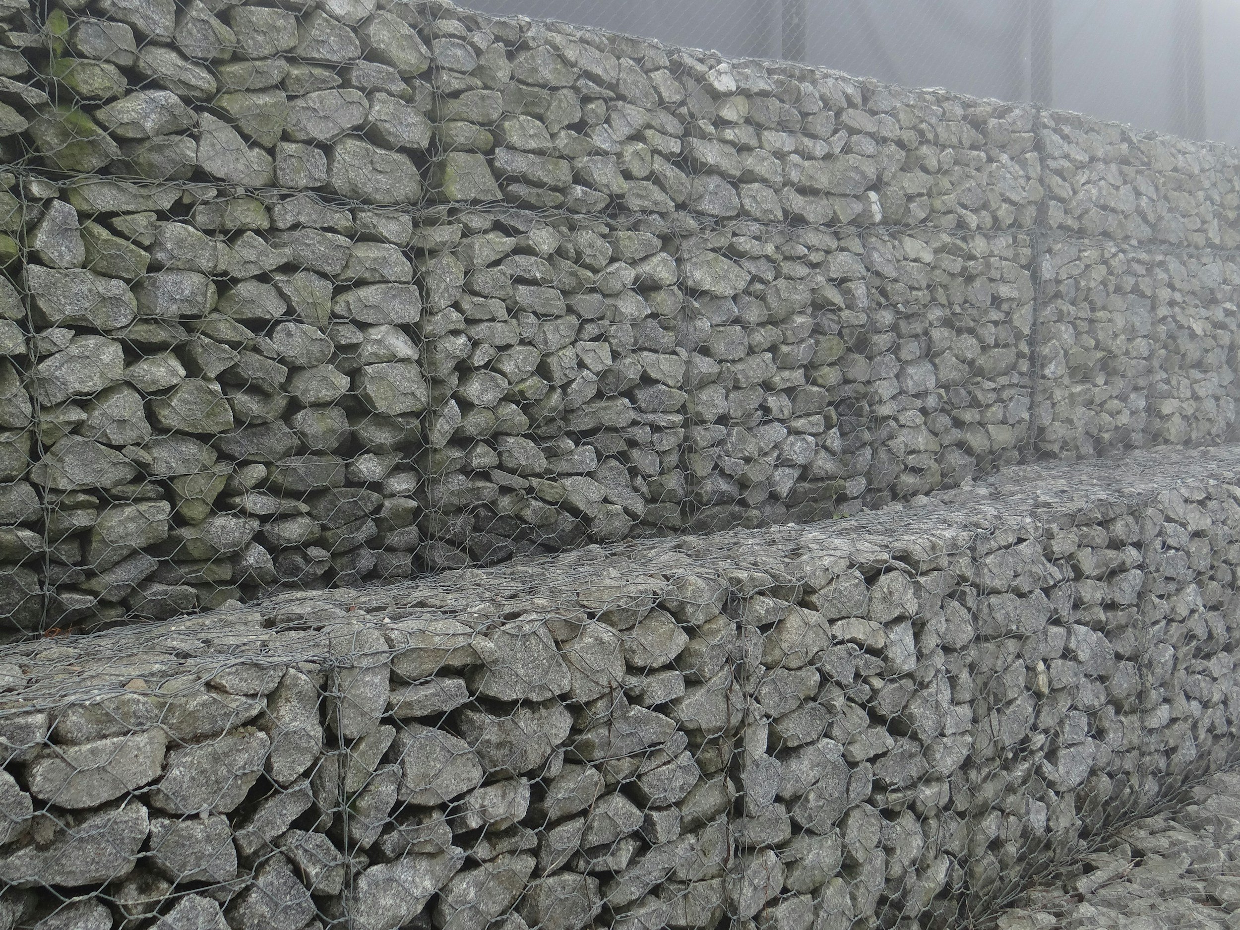Multi-level retaining wall system managing slope on new home build site