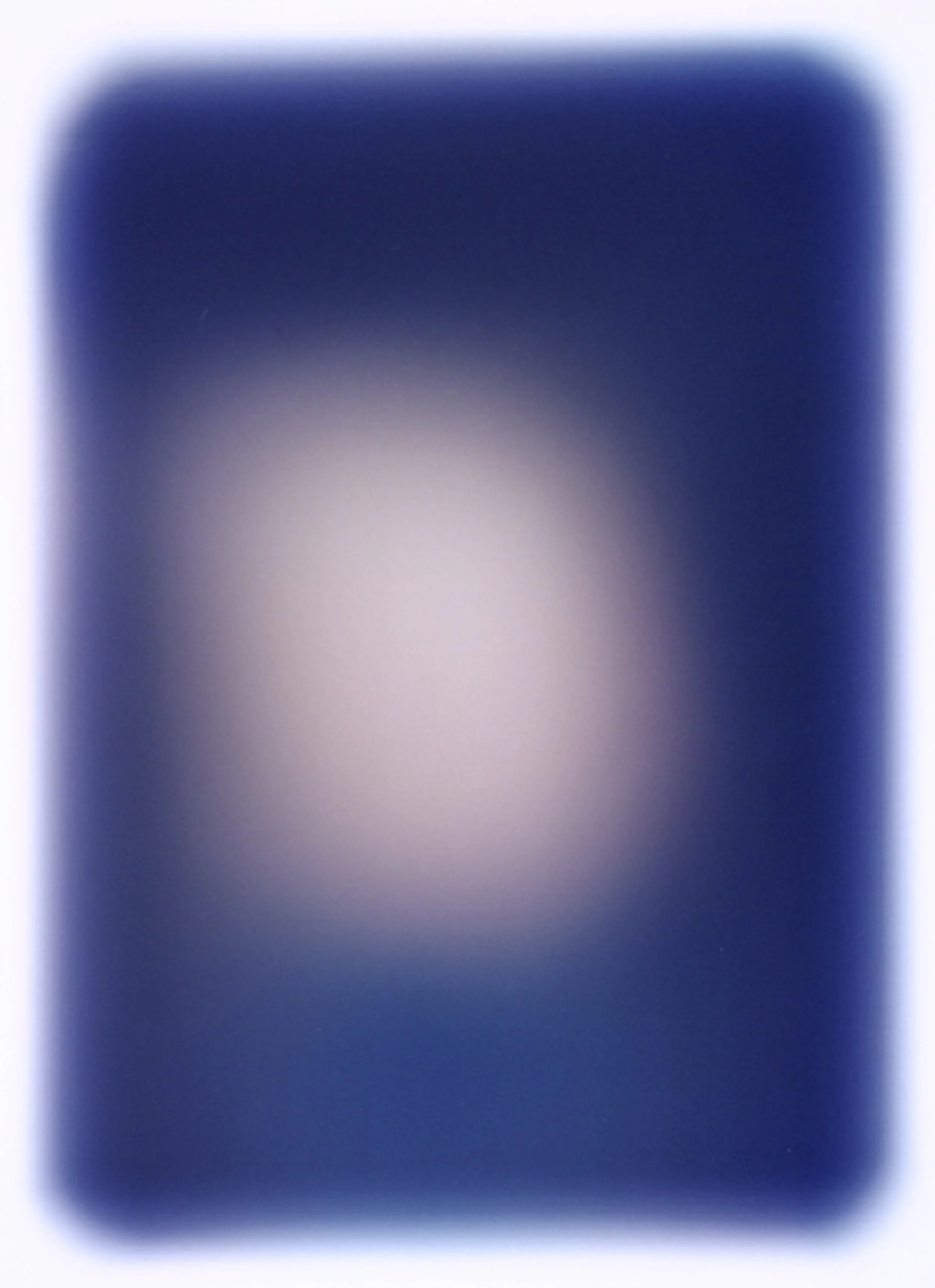 Close-up of a smartphone with a blurred, glowing screen.