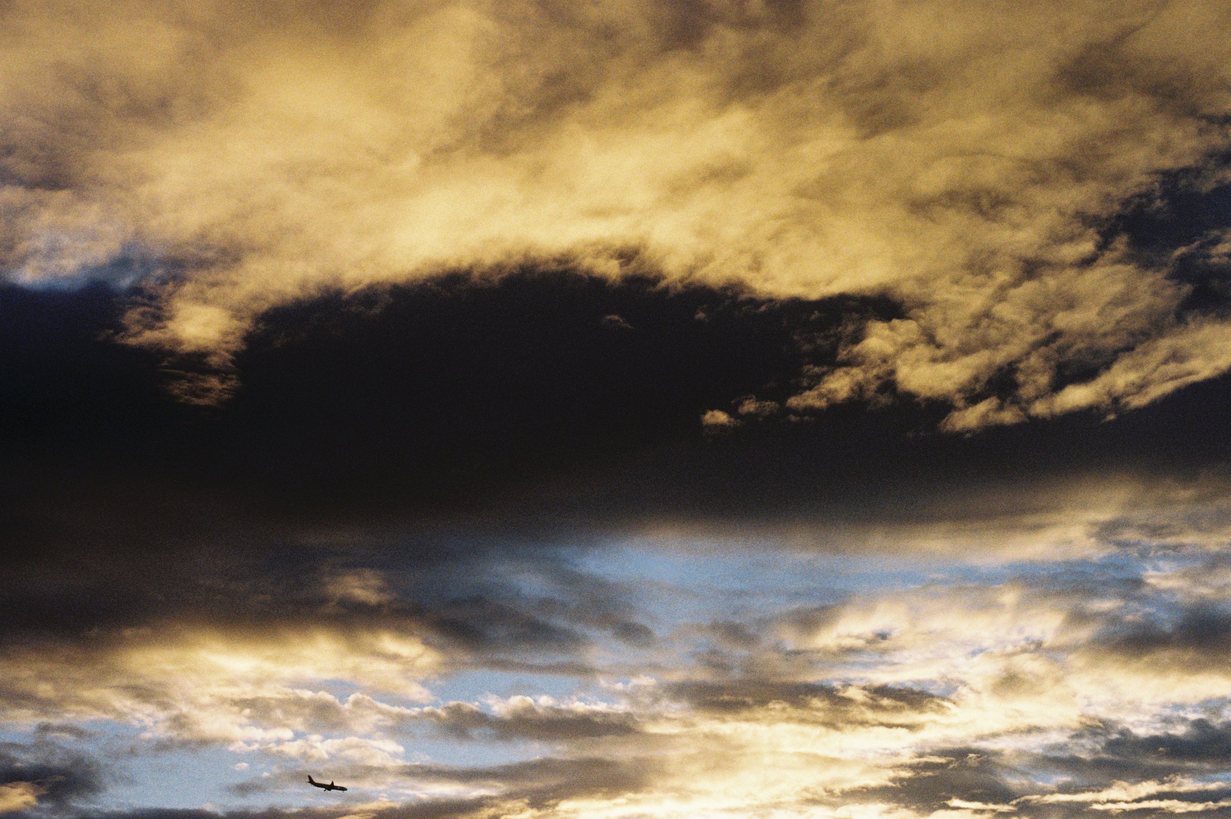 Colour photograph of a plane flying shot on film by Christian Pearson