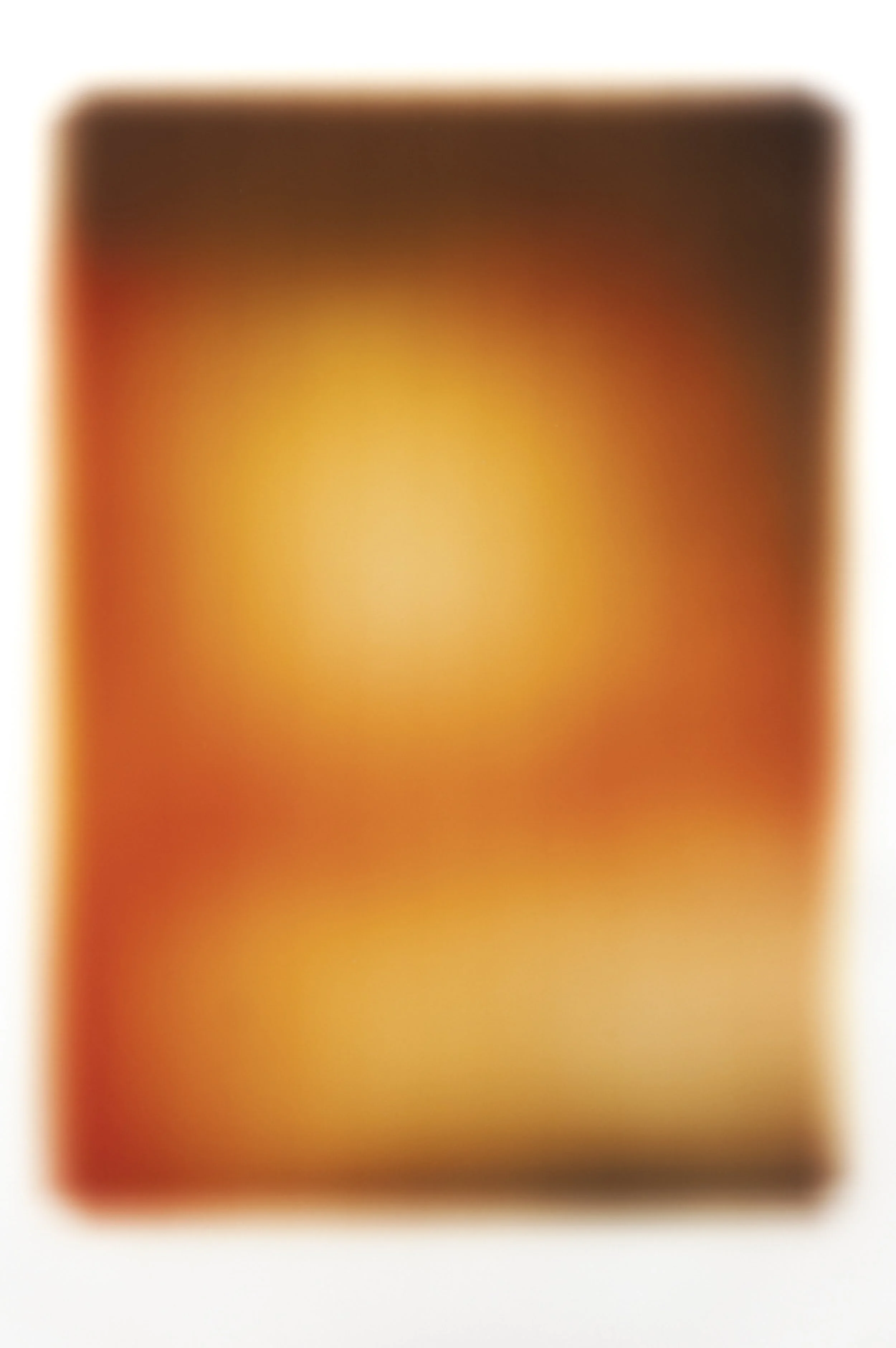 A blurred rectangular object with a gradient of black, orange, and yellow colors.
