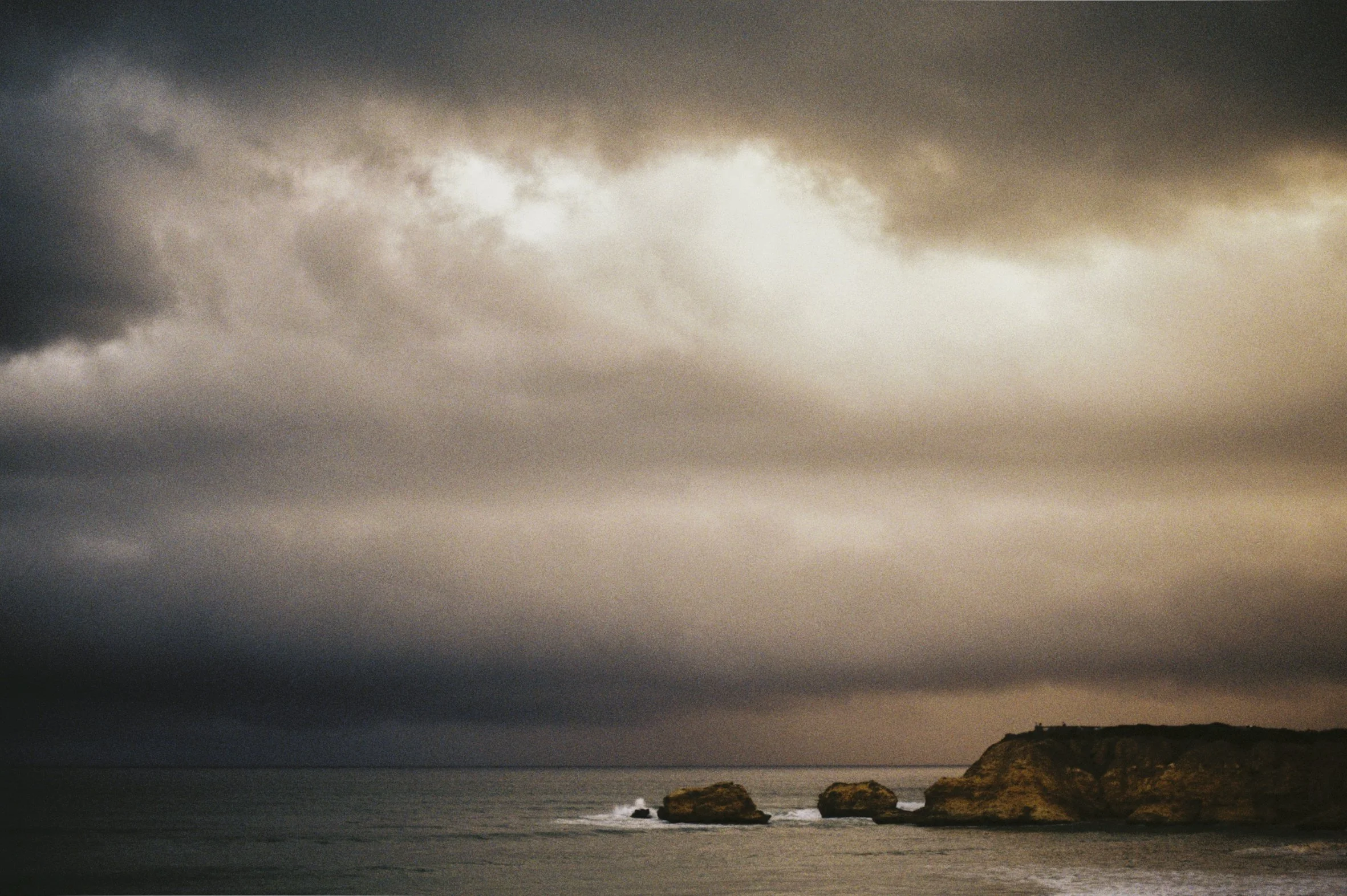A landscape image of a storm about to break over Torquay using film by Christian Pearson 2026