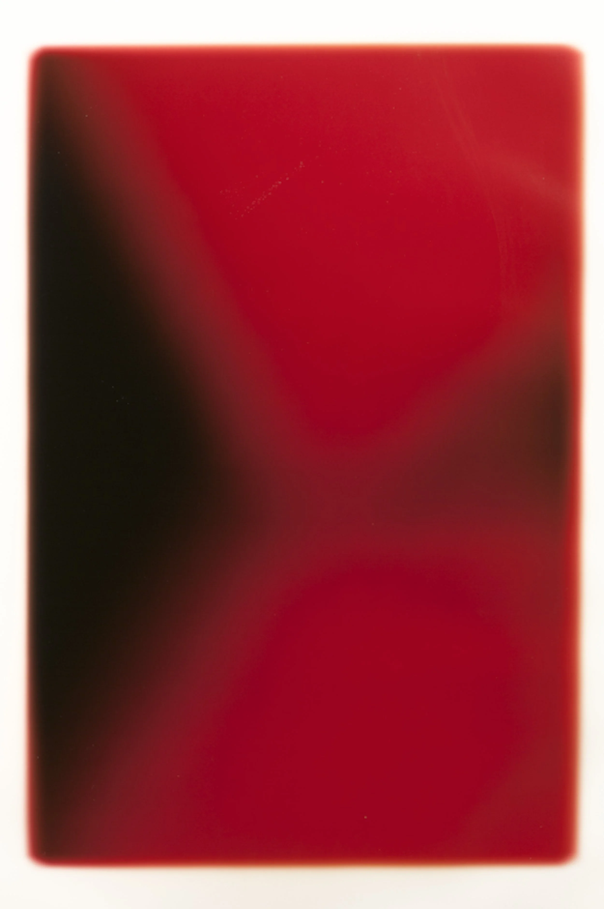Close-up of a red hardcover book with a slightly worn edge.