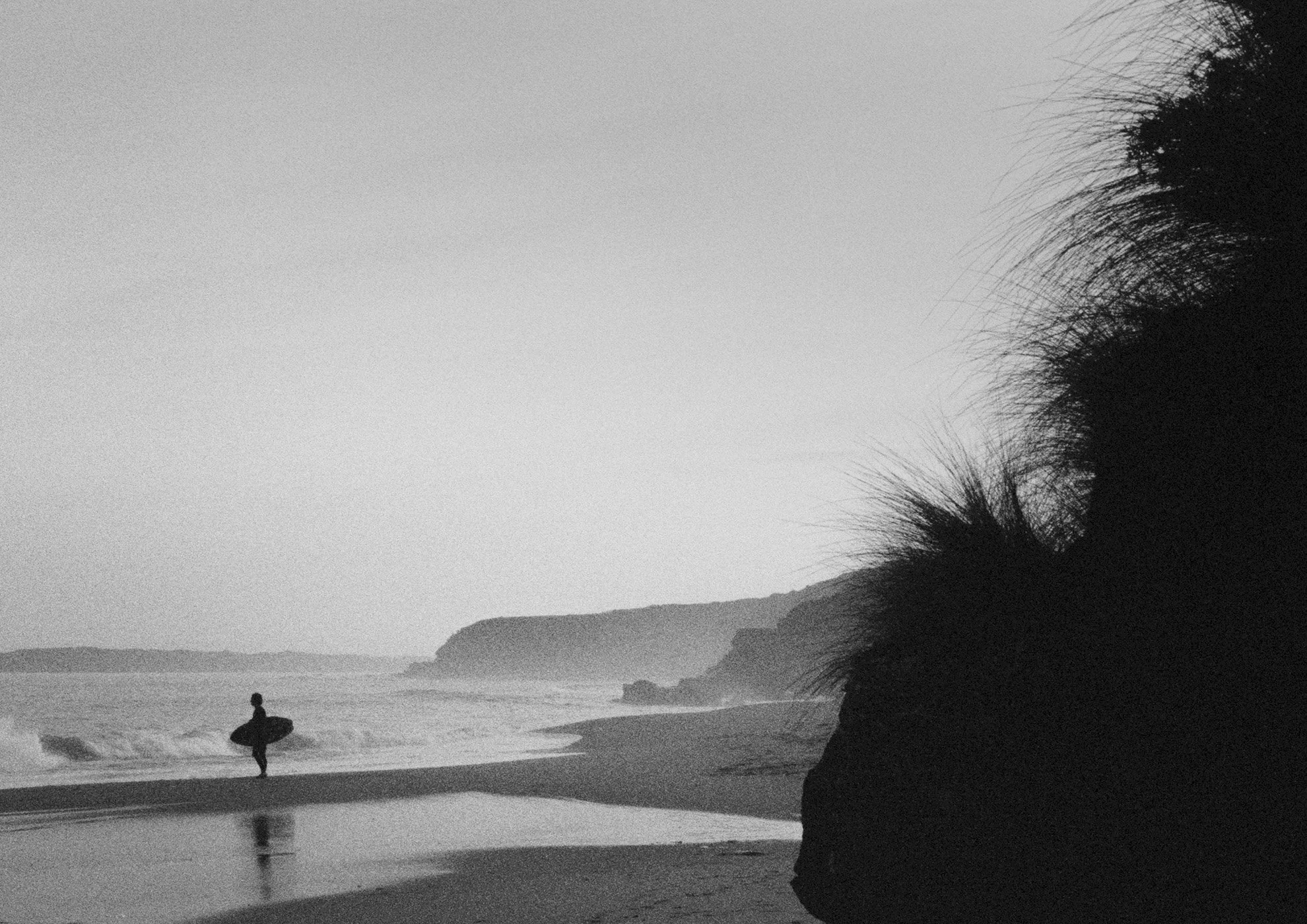 Black and white photo of a surfer by Christian Pearson