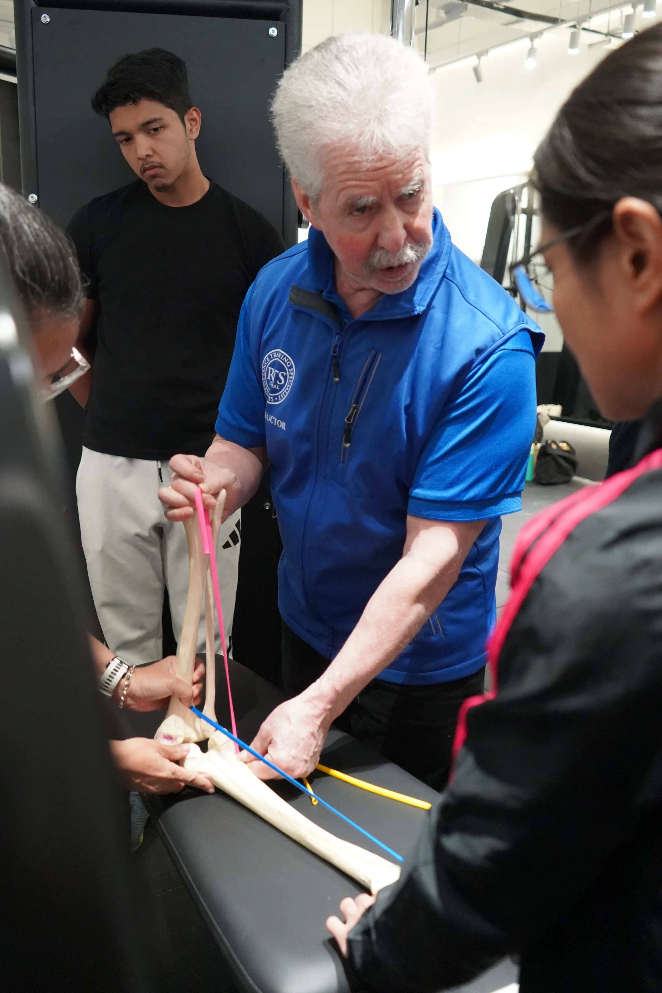 Dr Mark Slavin demonstrating the mechanics of the knee flexors using a skeleton on an RTS Level 1 course in Singapore