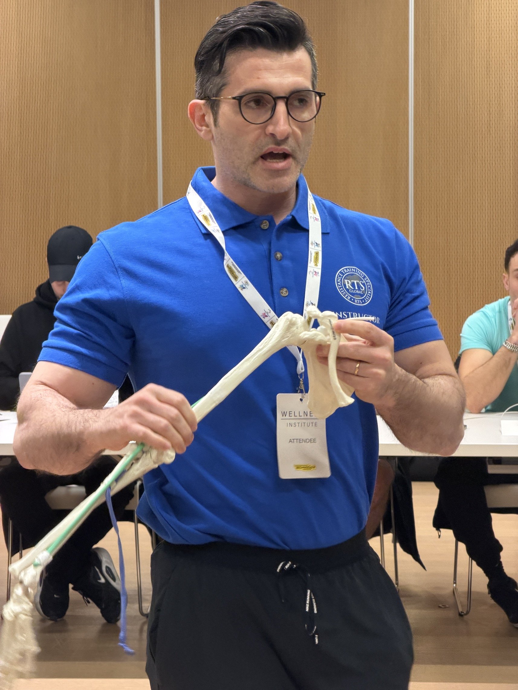 Dr Andrea Mariani using a scapula and humerus bone to explain to students the function of the glenohumeral joint during an RTS Level 1 course in Italy