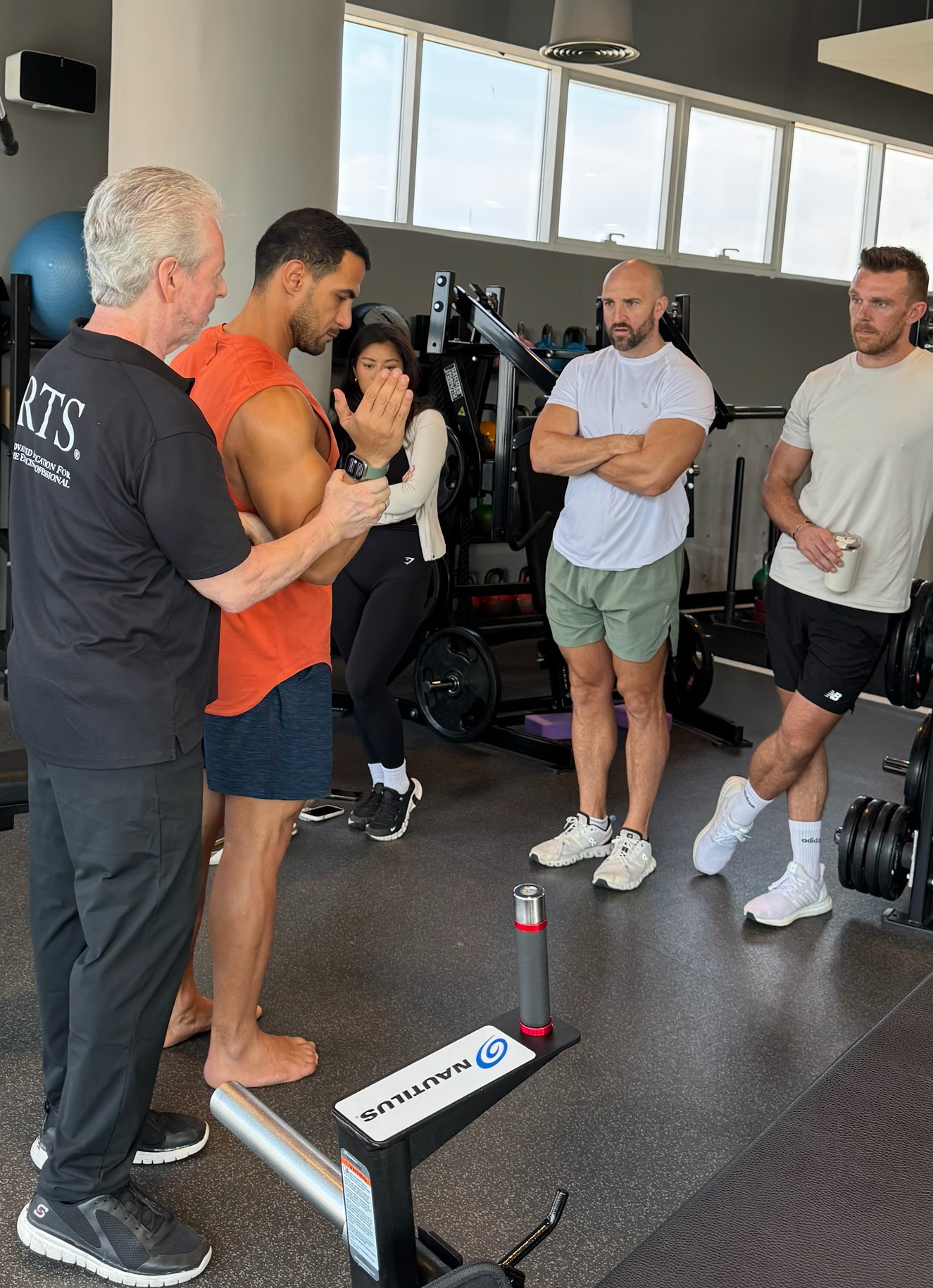 Dr Mark Slavin demonstrating to students in Australia what positions of adduction and external rotation are required for a client to perform a pulldown into the bottom position