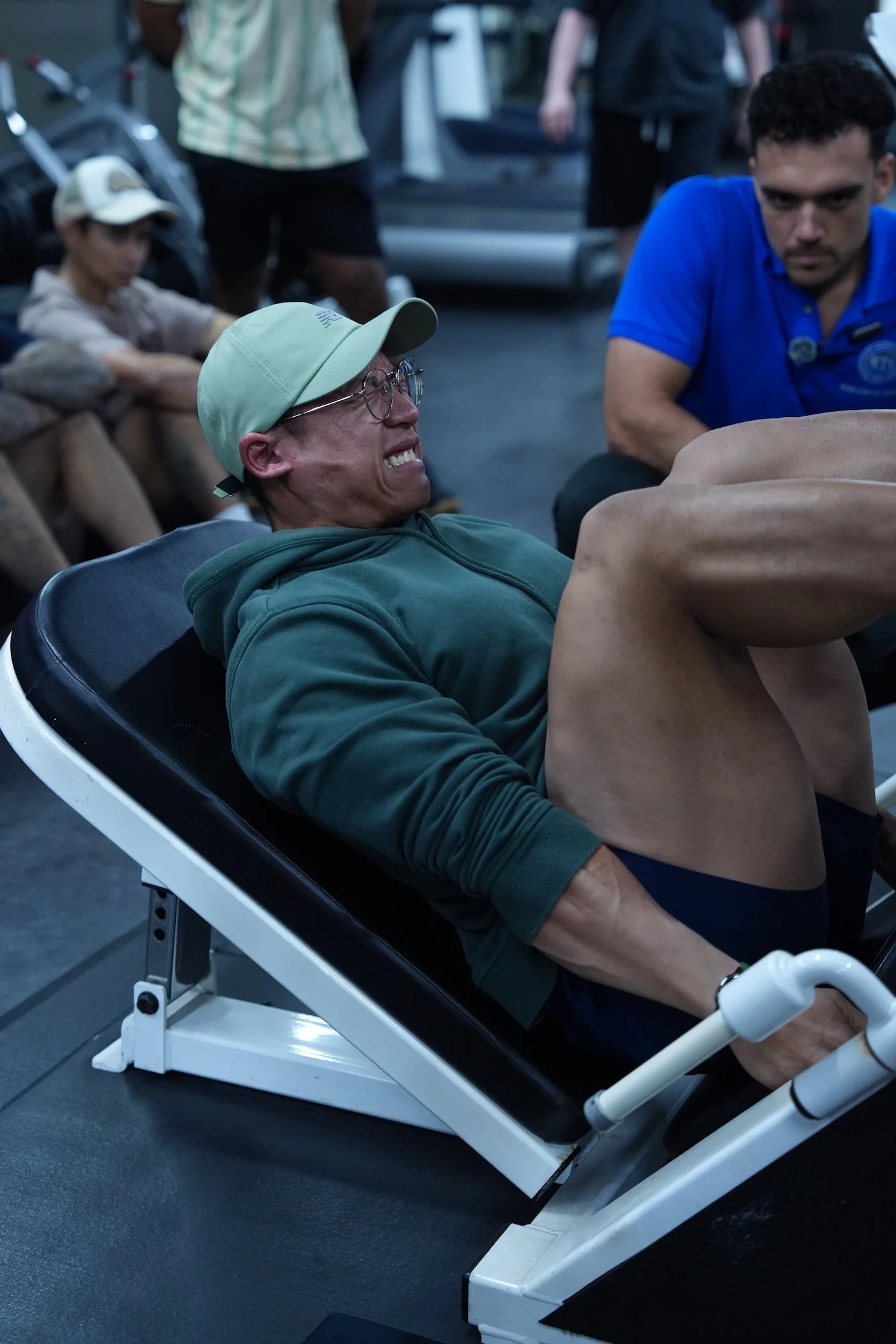 Benny Price pushing a student to their limits on a Leg Press during a practical session of an RTS Level 2 course in Singapore in 2026