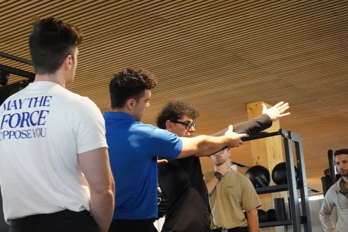 Benny Price showing students how to align the plane of the glenohumeral axis with the plane of resistance during an RTS Level 1 practical workshop in Italy