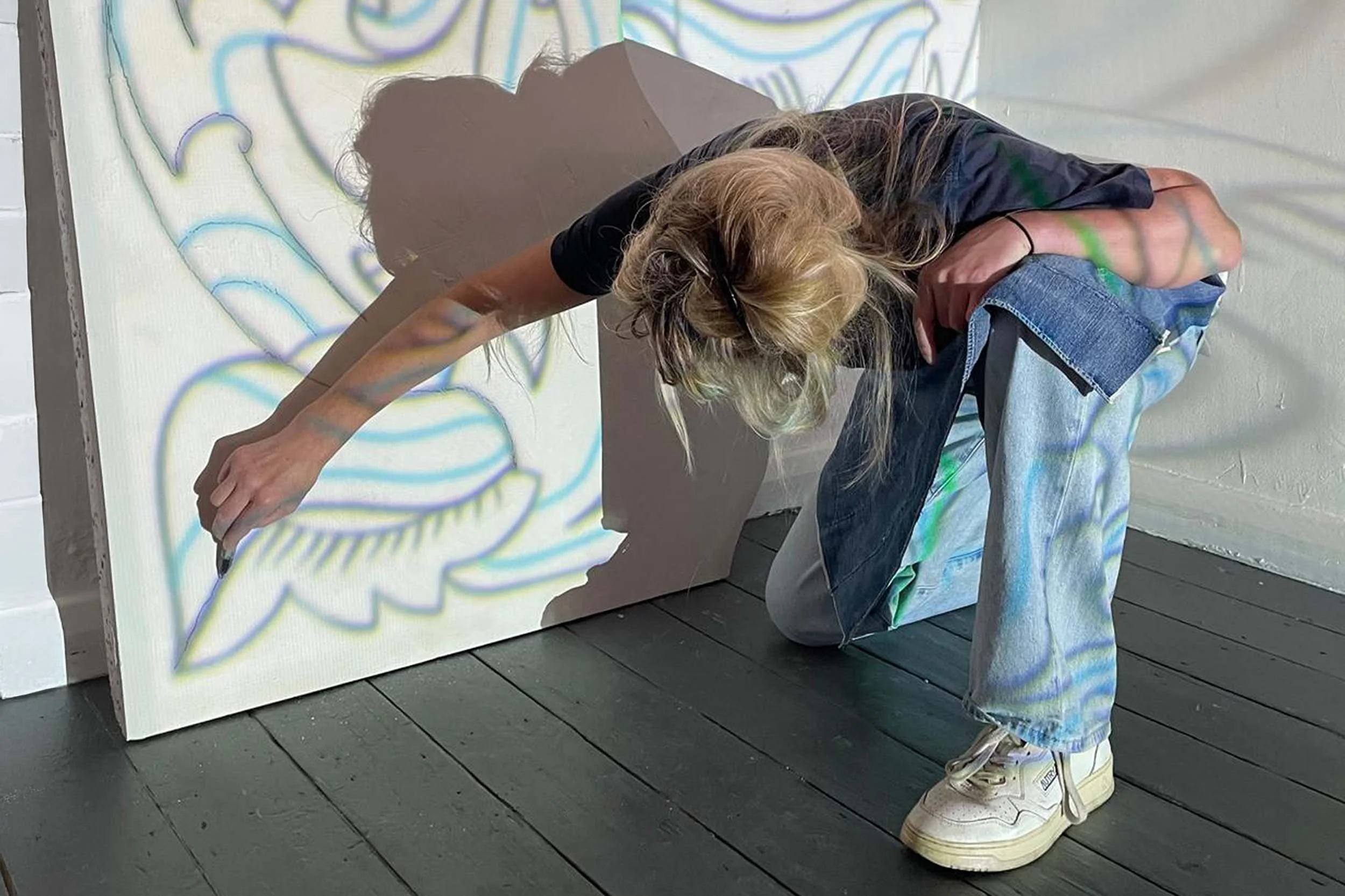 Petra Börner drawing on plaster mural relief in Helen Johannessen London studio.