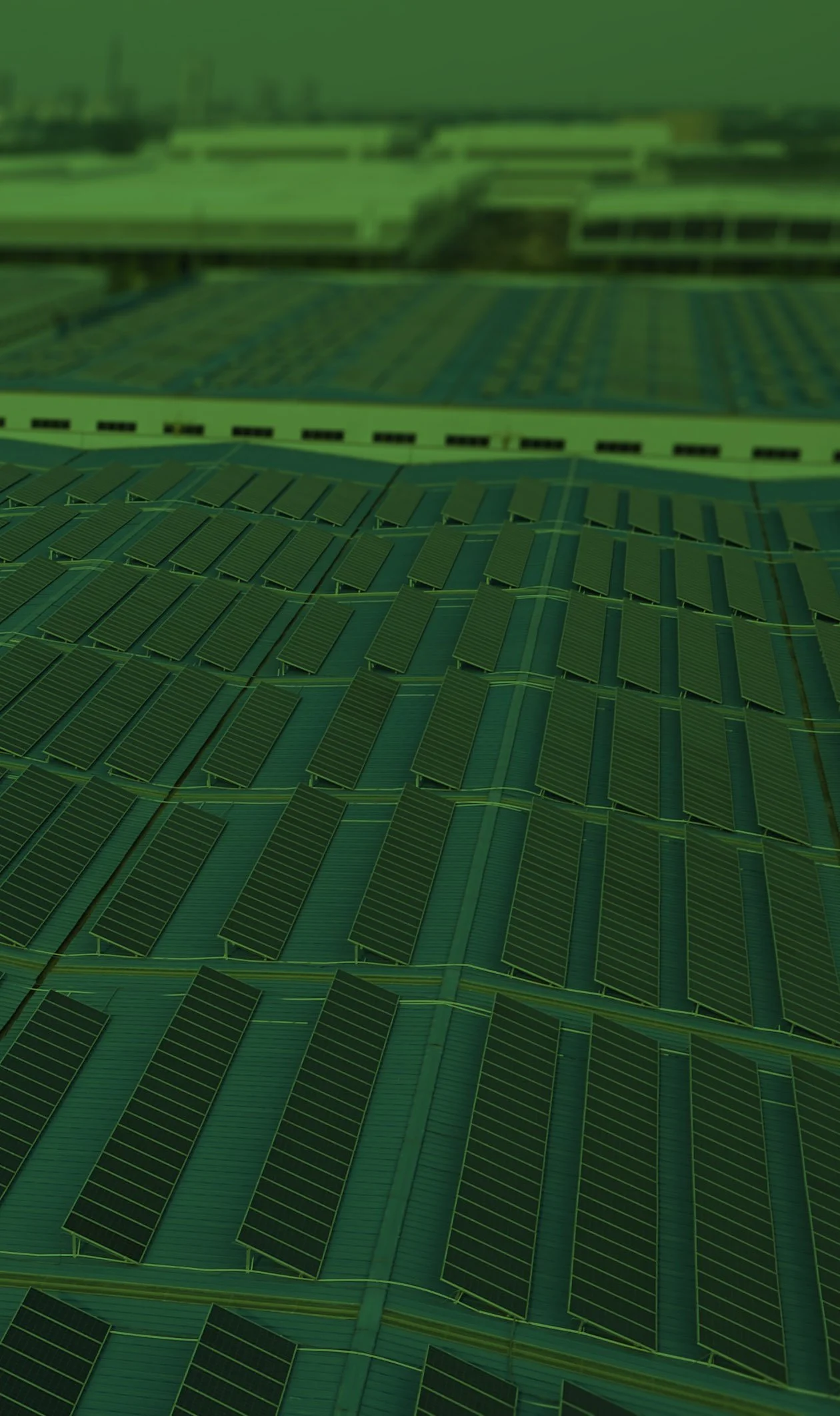 Aerial view of a solar panel installation on a large industrial or commercial roof.