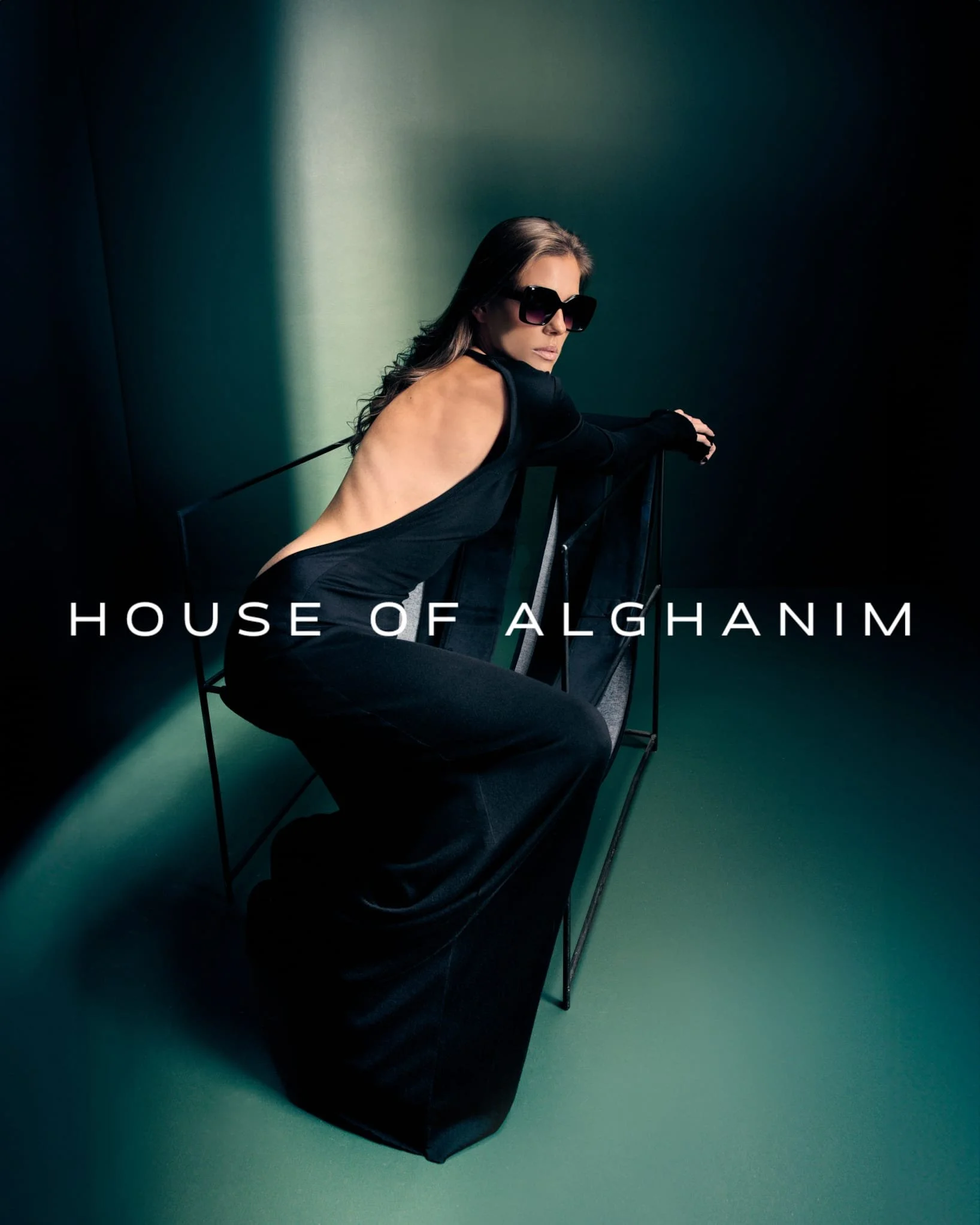 A model wearing a black, backless dress designed by House of Alghanim