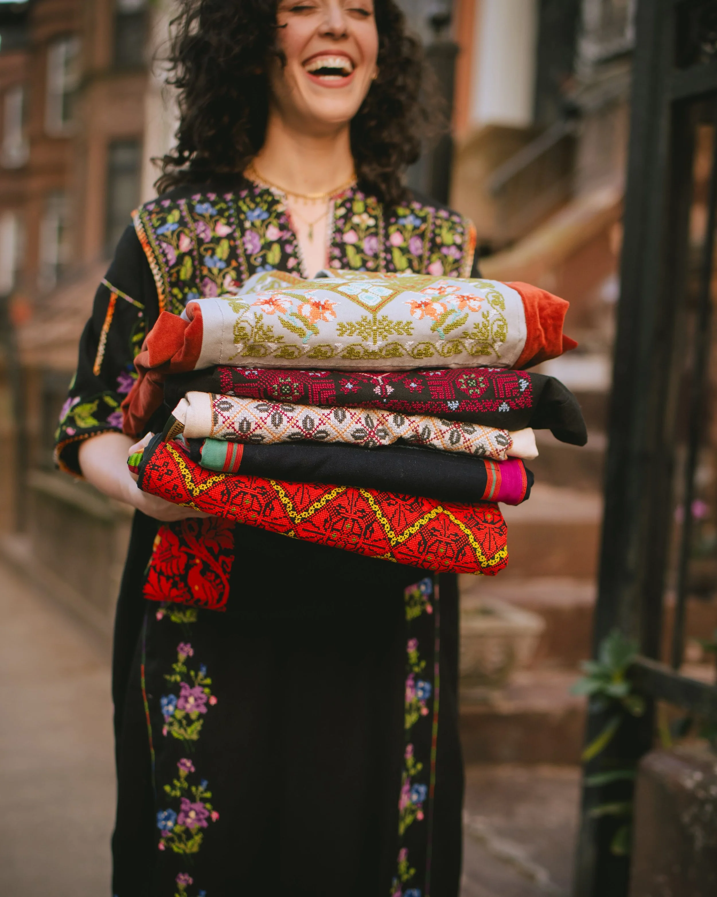 Lina's Thobe | Lina carrying embroidered thobes