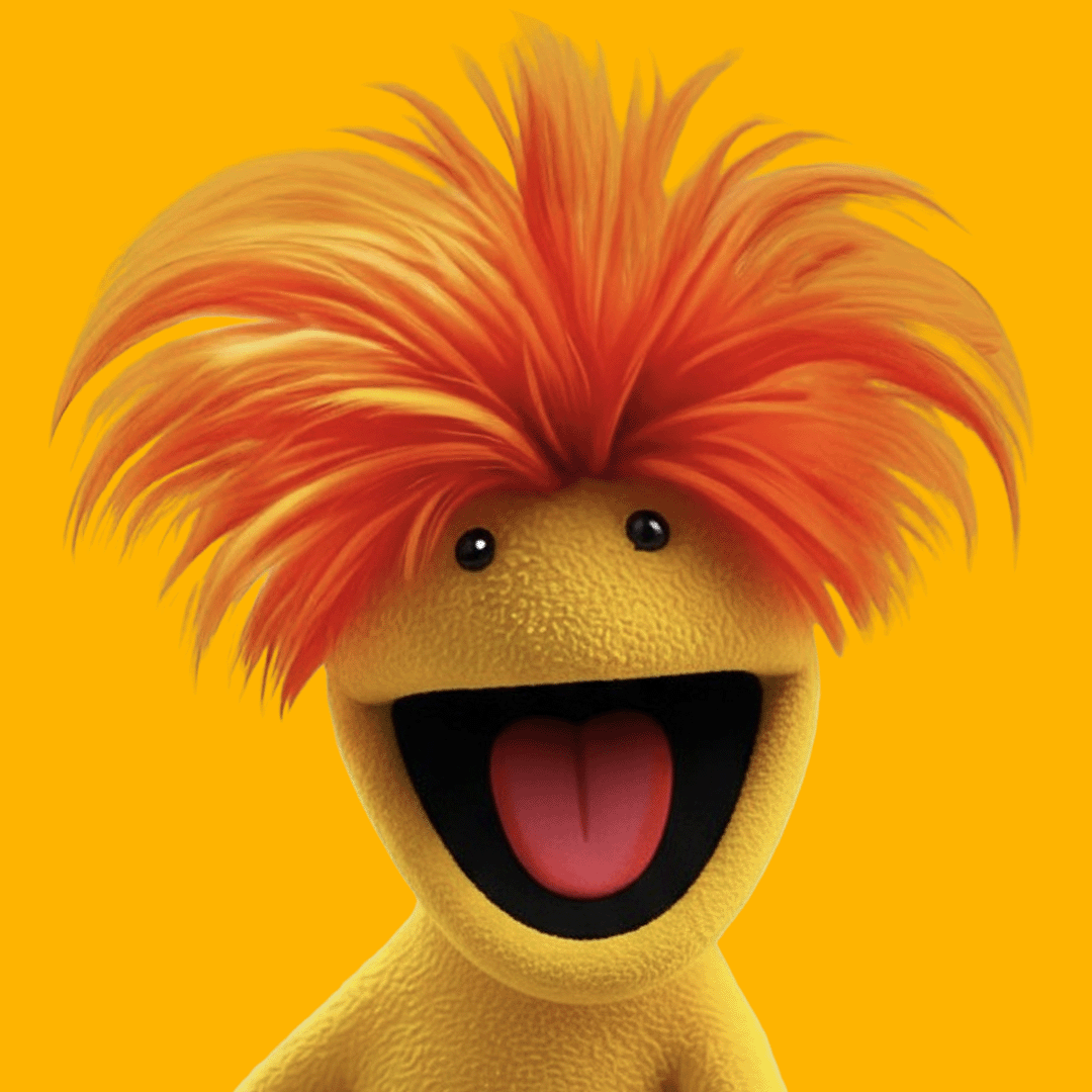 A cheerful yellow puppet character with a large open mouth, pink tongue, and small black eyes, featuring spiky orange and yellow hair against a plain yellow background.