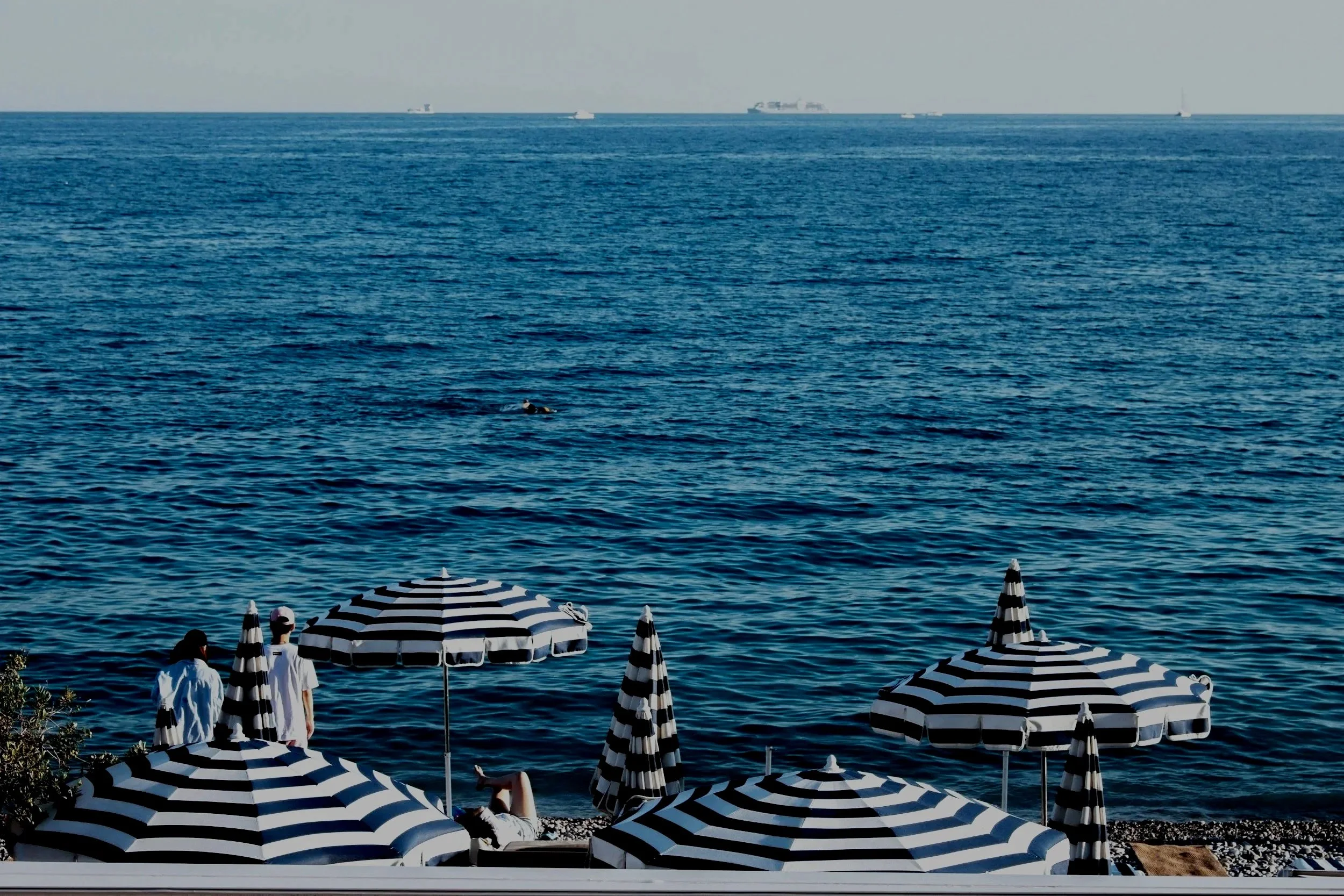 Blue and White Stripey umbrella on Nice beach