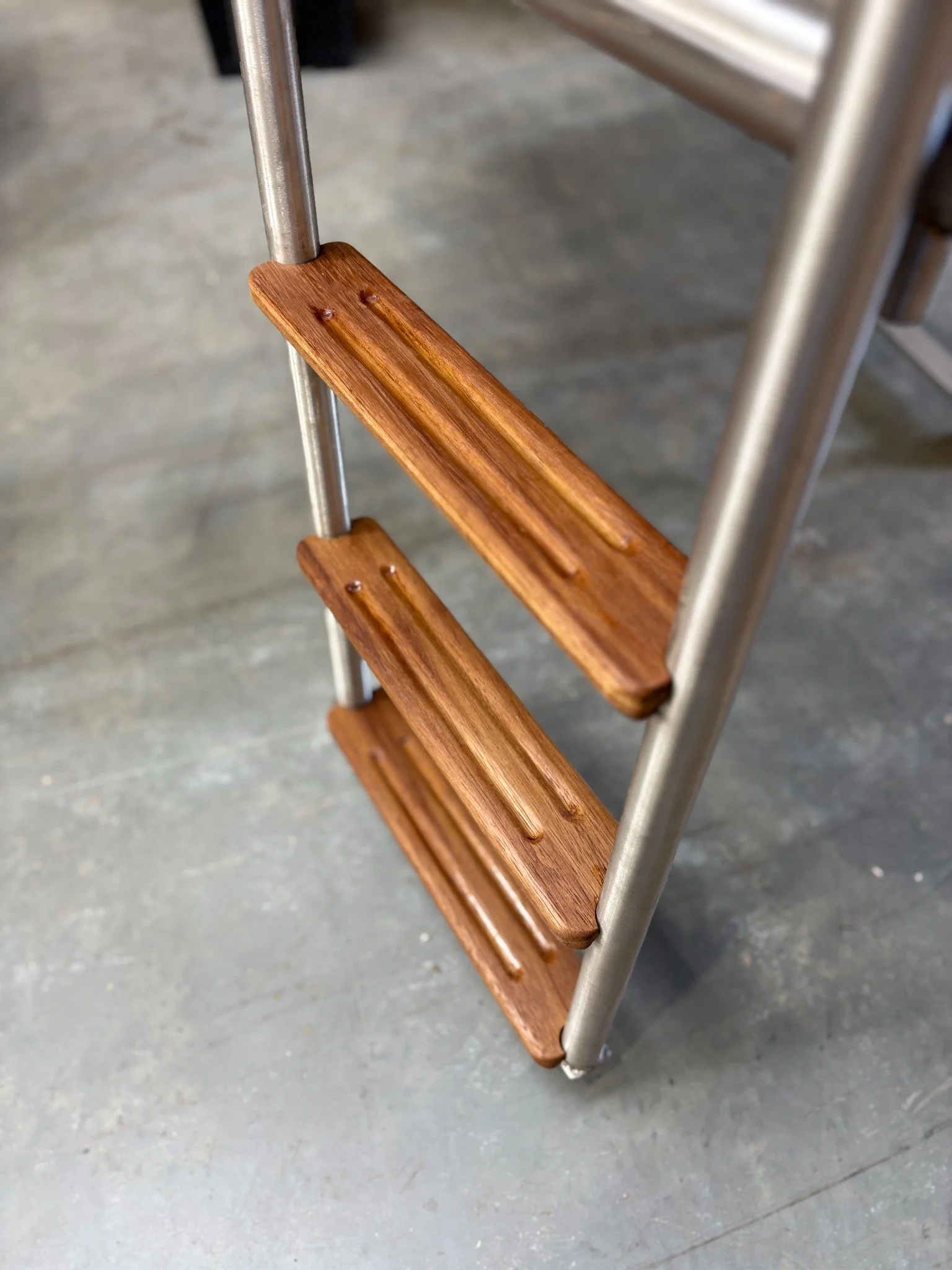 Close-up of timber ladder steps on the custom swim platform