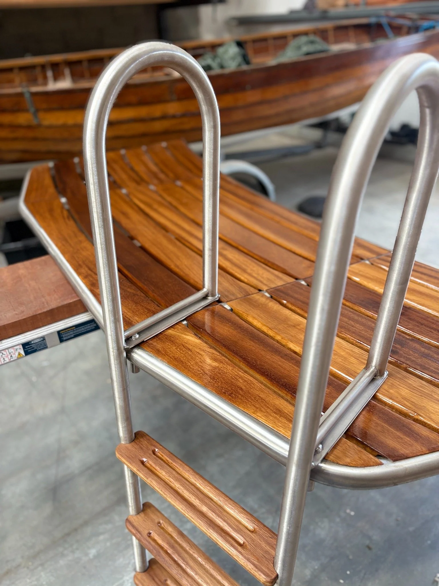 Ladder and timber decking on a custom swim platform, viewed from above
