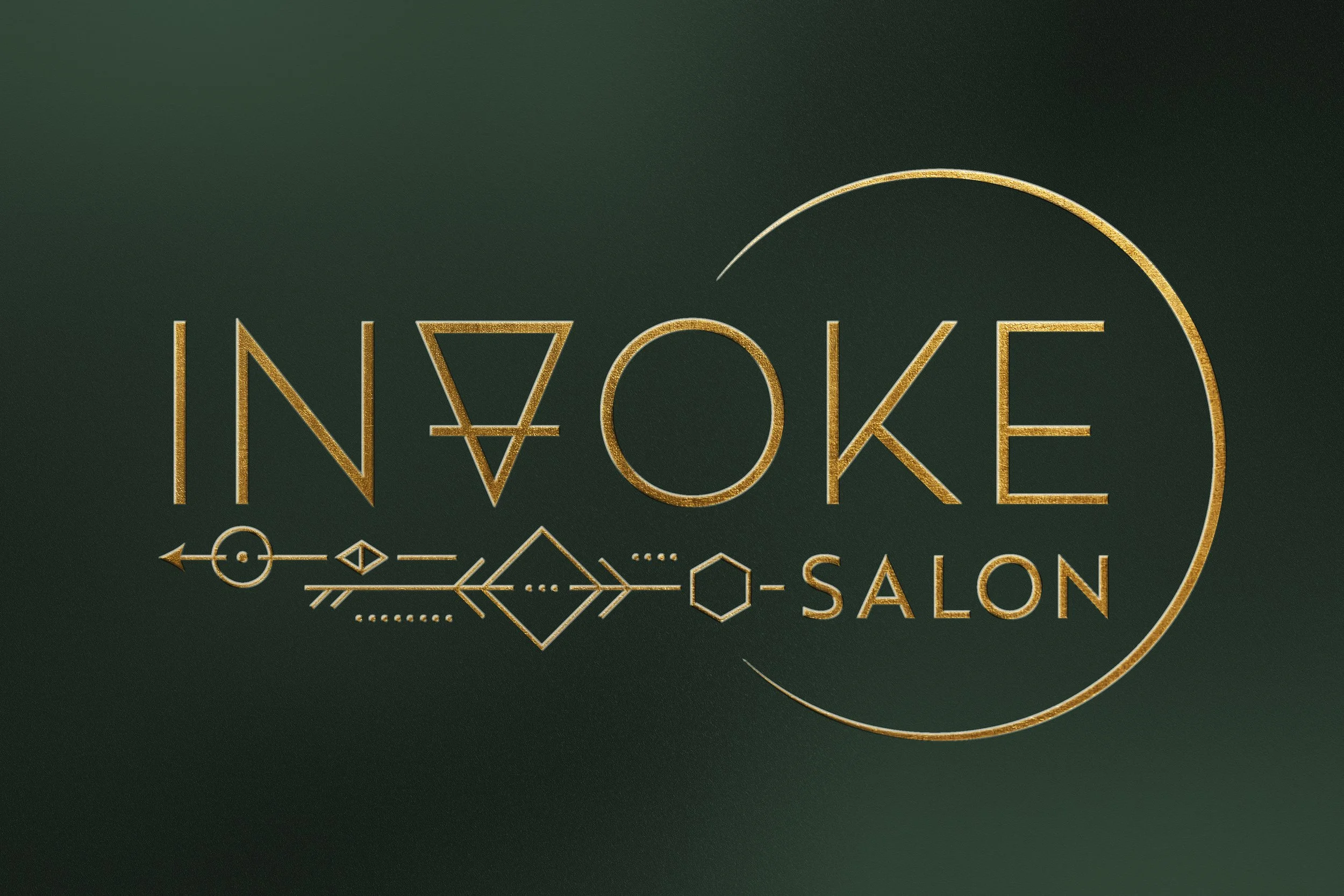 Gold geometric logo with the words 'Invoke Salon' on a dark green background.
