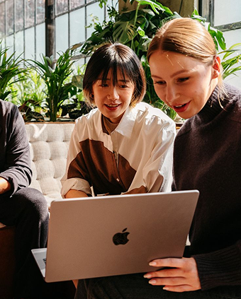Two women working on a laptop
