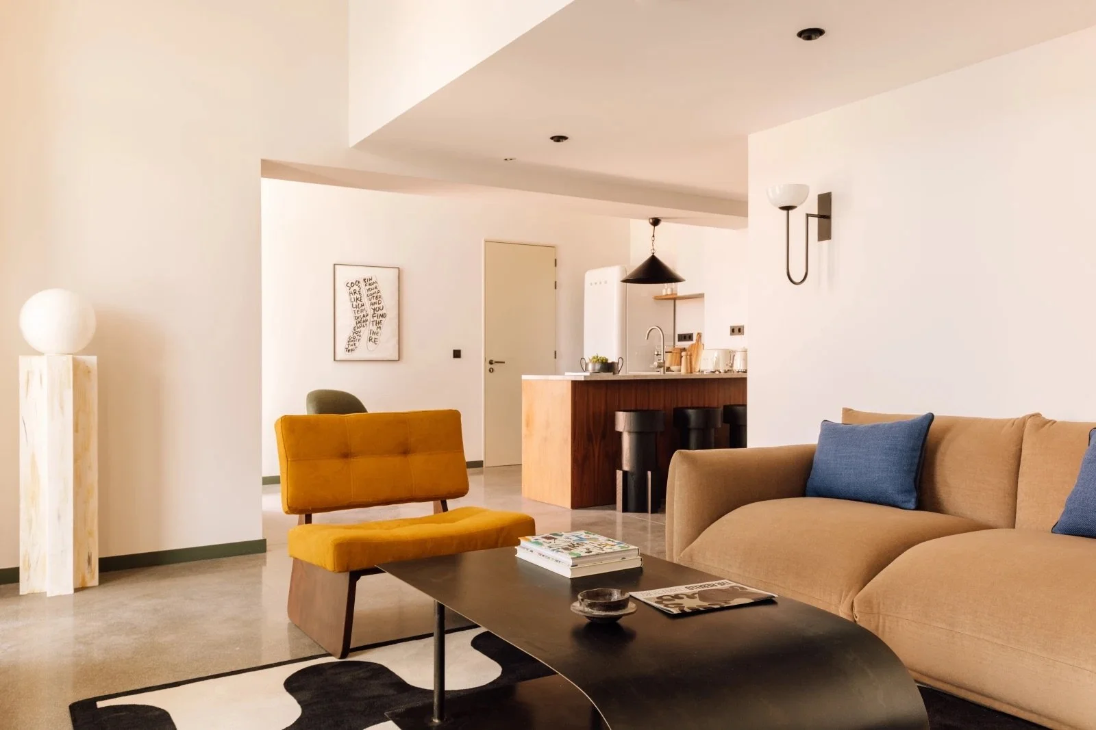 Spacious living room at The Rebello hotel in Porto, Portugal, with contemporary furnishings, open-plan kitchen, and stylish lounge area—perfect for travelers looking for upscale boutique hotels in Porto’s riverside district.