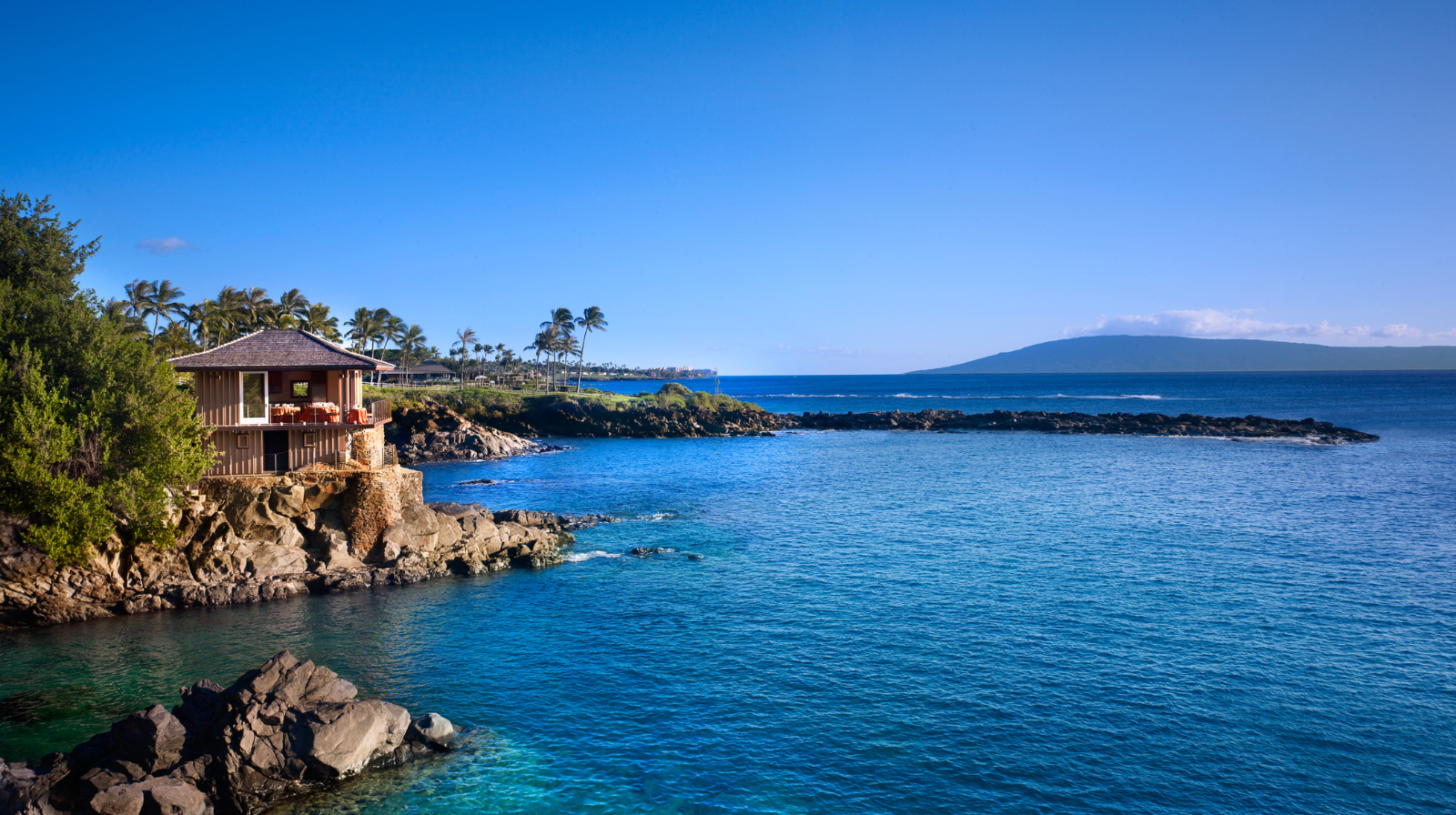 Montage Kapalua Bay Maui oceanfront luxury resort with turquoise water and volcanic rock coastline Hawaii