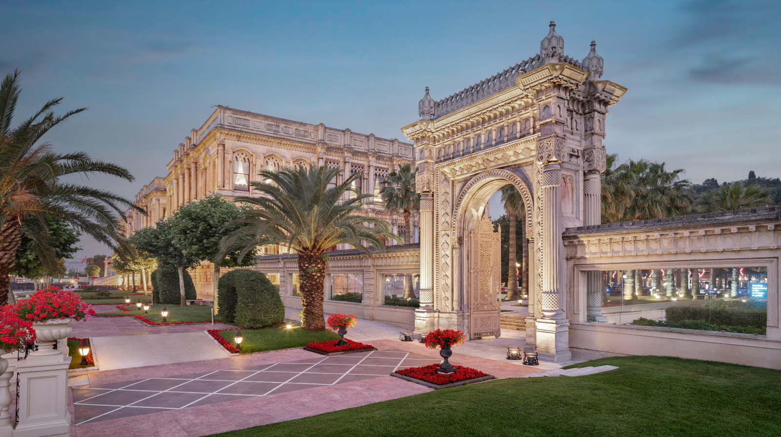Ottoman palace architecture with manicured gardens and ornate archways at Çırağan Palace Kempinski on the Bosphorus