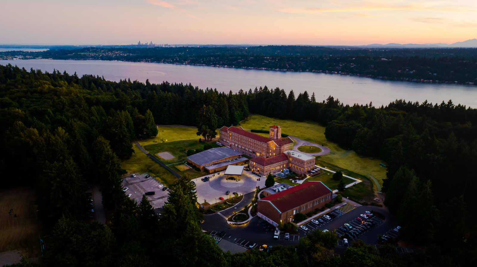 Aerial view of historic Lodge at St. Edward Park surrounded by old-growth forest on Lake Washington near Seattle